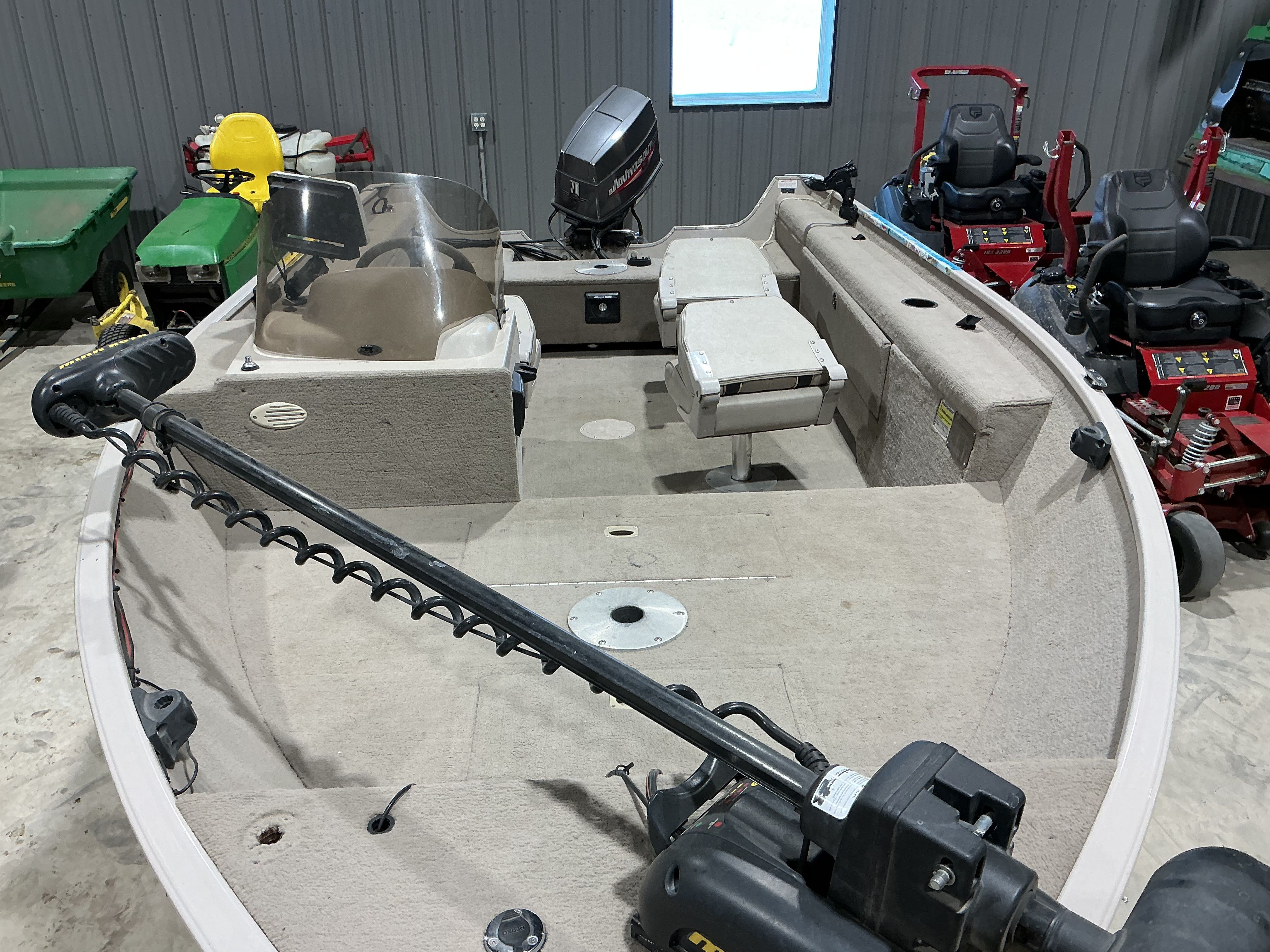 1999 Sylvan EXPEDITION boat interior with motor and seating.