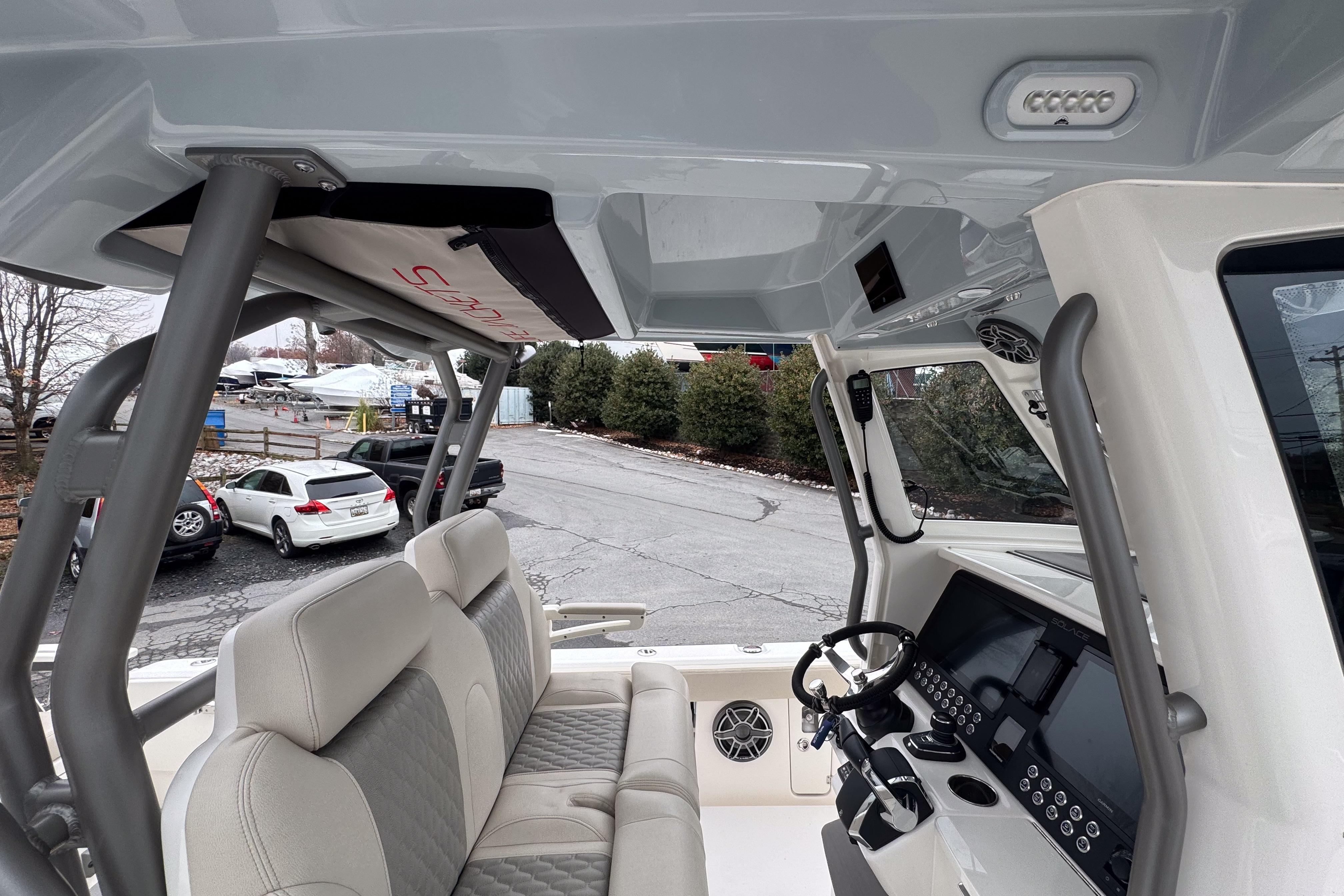 Interior view of 2025 Solace 30 HCS boat, featuring modern helm and seating.