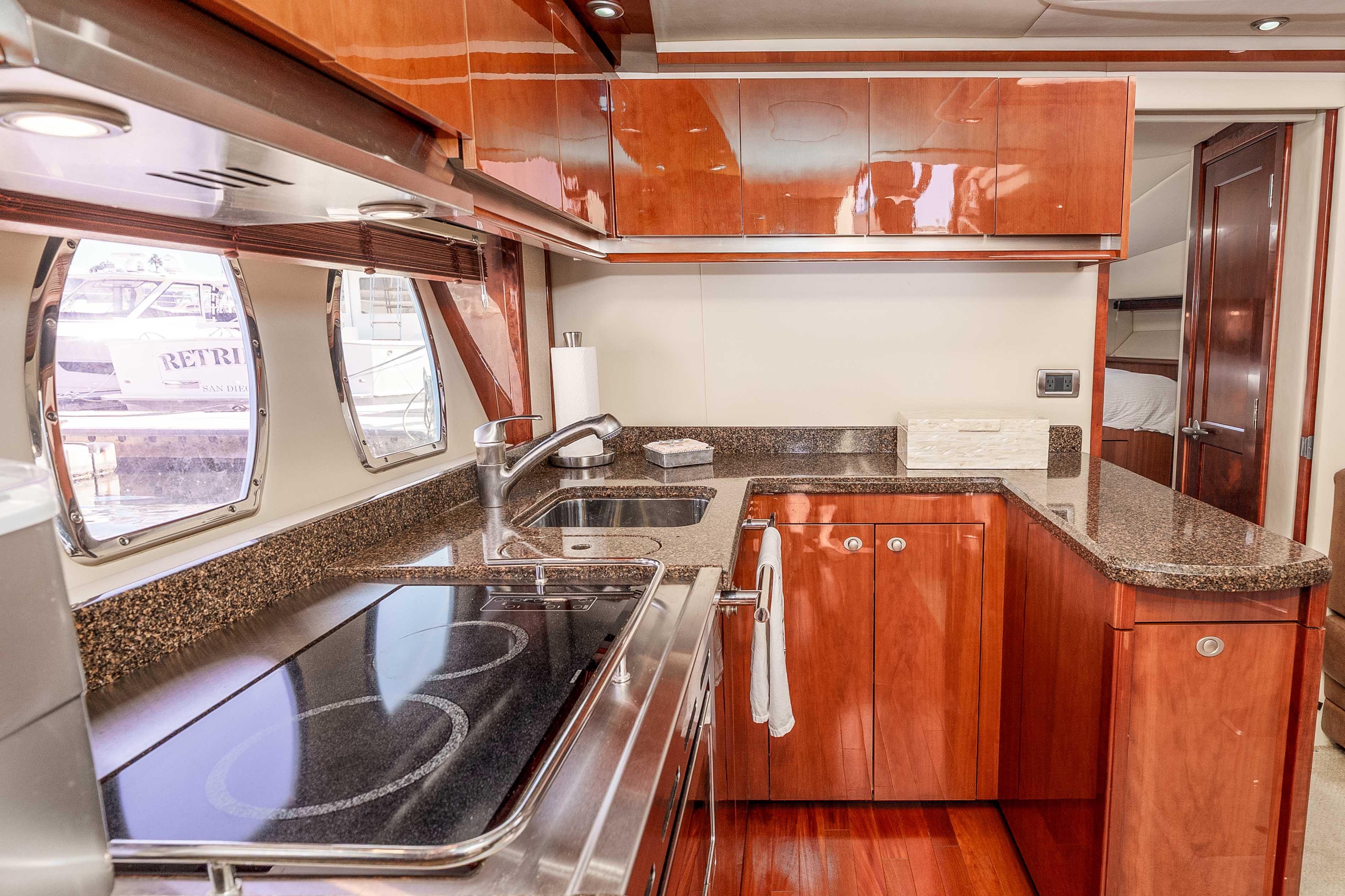 Luxurious kitchen interior of 2007 Sea Ray 48 Sundancer yacht with modern amenities.