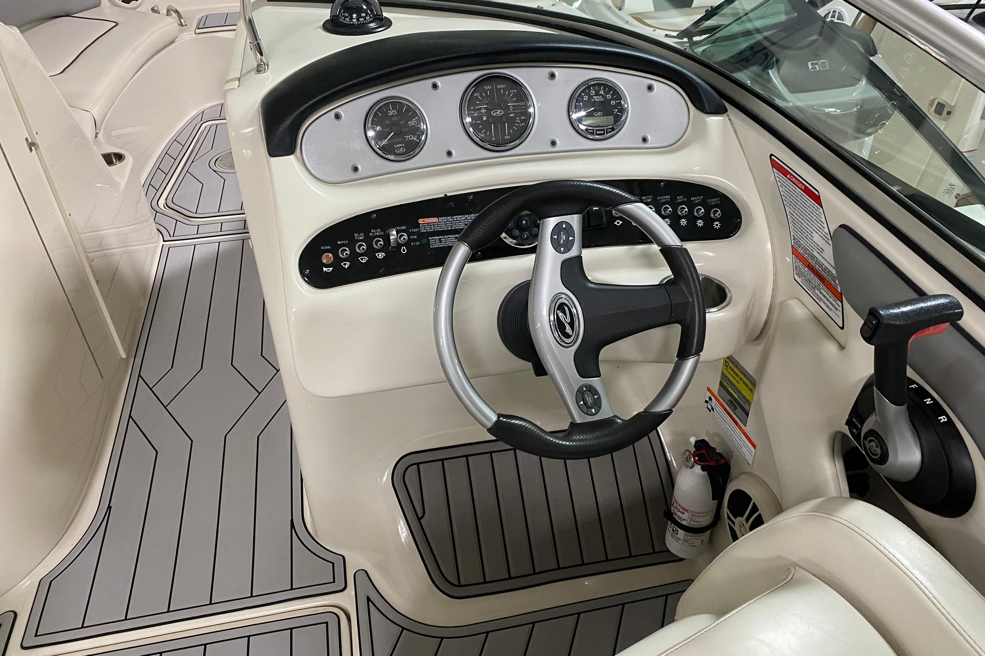 2008 Sea Ray 240 Sundeck boat dashboard with steering wheel and control panel.