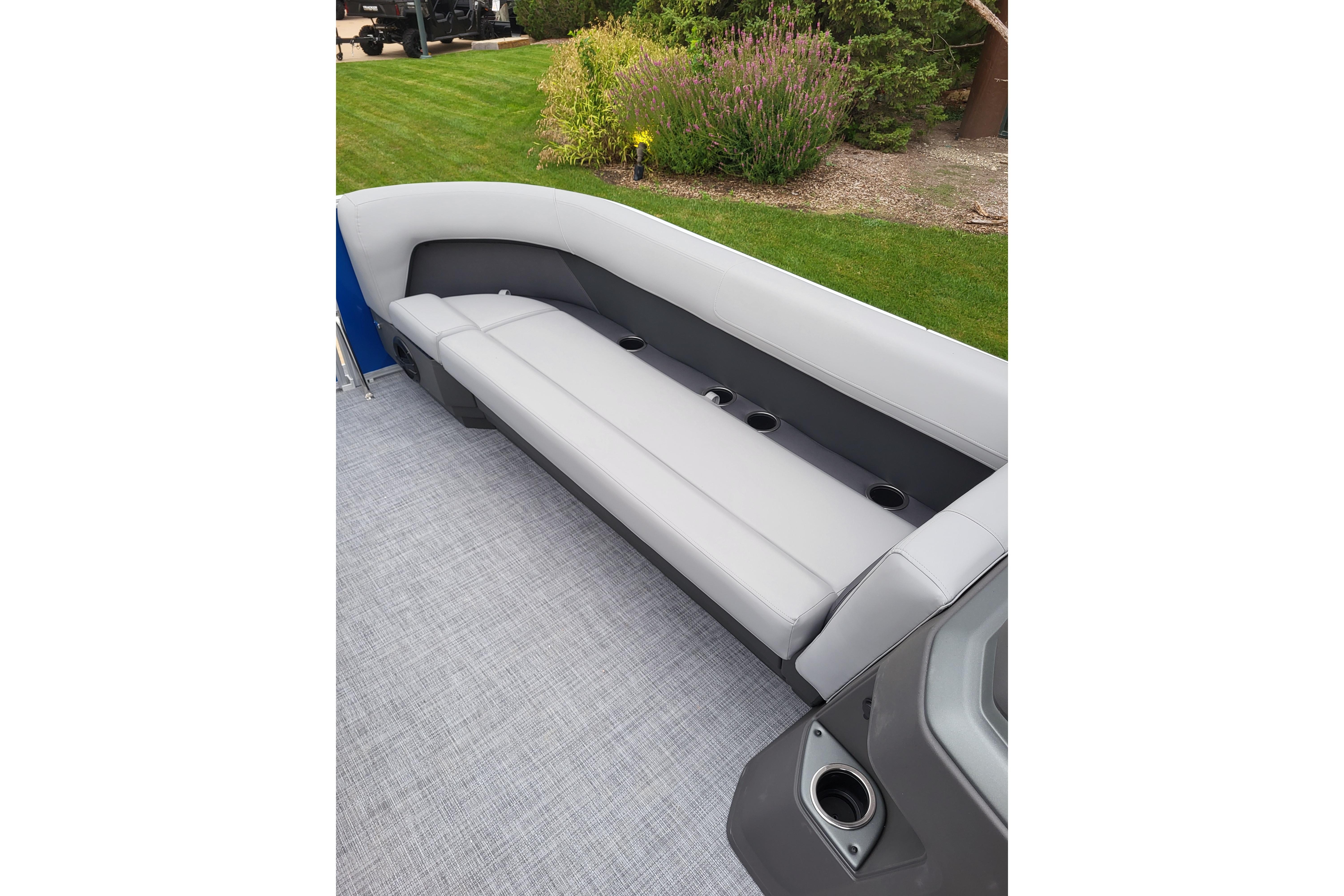 2026 Sun Tracker Party Barge 18 DLX interior with gray seating and cup holders.