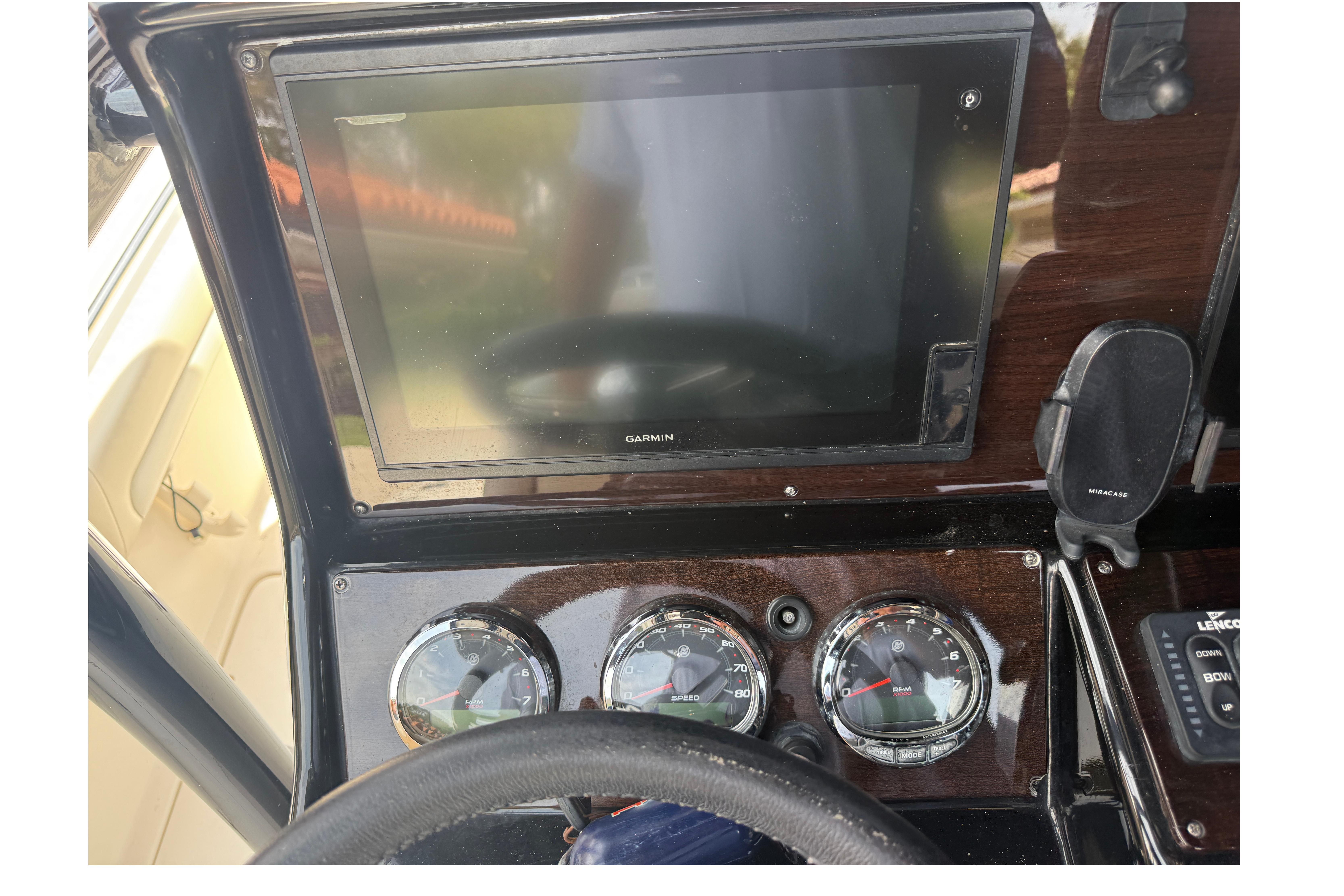 Dashboard of a 2015 Blackwood 27 boat with Garmin display and gauges.
