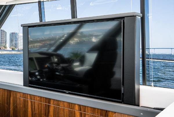 Flat-screen TV on 2021 Riviera 5400 Sport Yacht with ocean view.