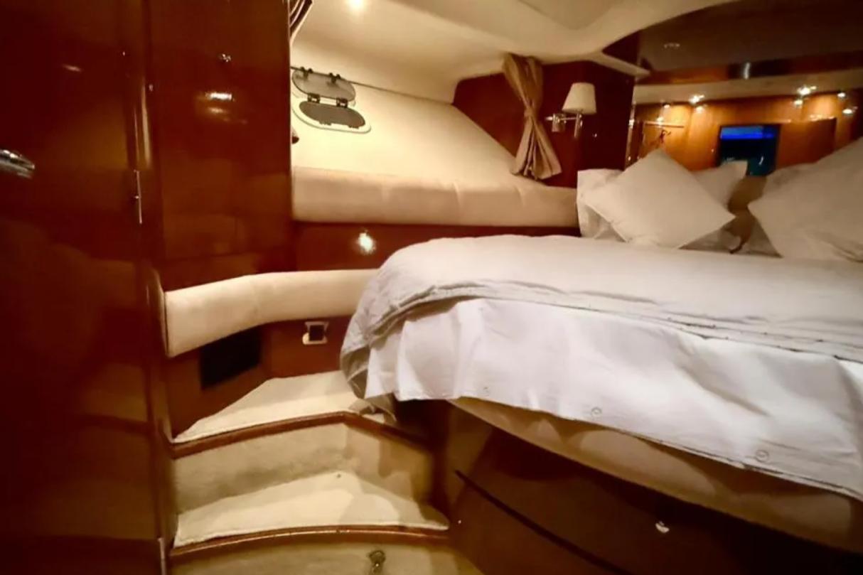 Luxurious cabin interior of 2005 Jeanneau Prestige 46 yacht with cozy bedding.