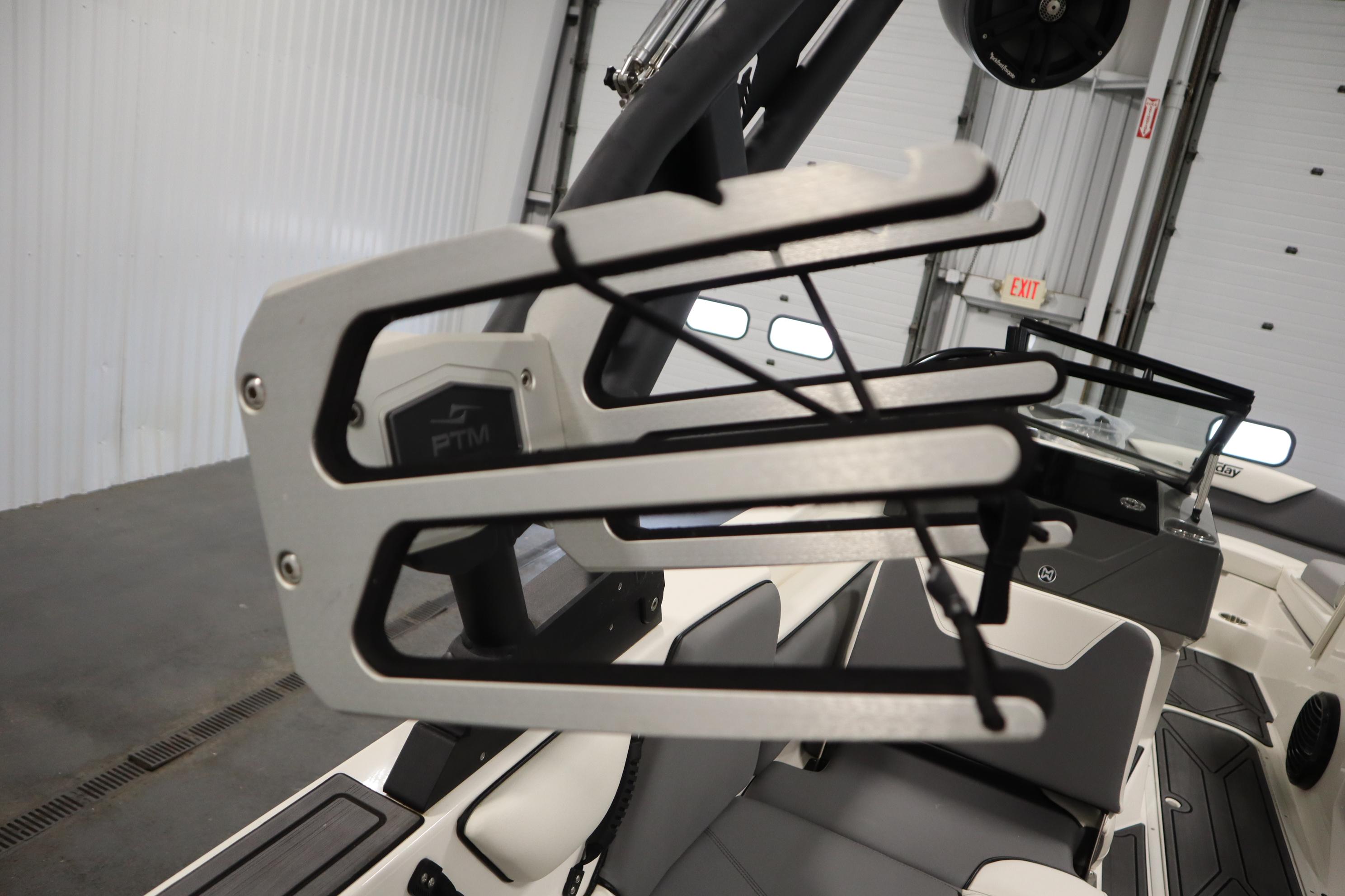 2023 Heyday WT Surf boat interior with wakeboard rack and seating.