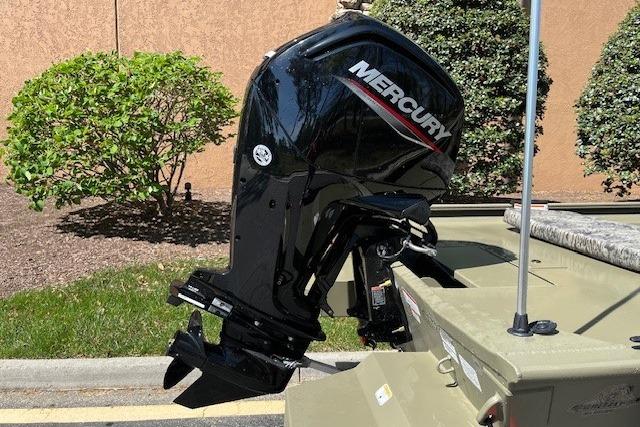 2026 Tracker Grizzly 1860 CC boat with Mercury outboard motor, parked outdoors.