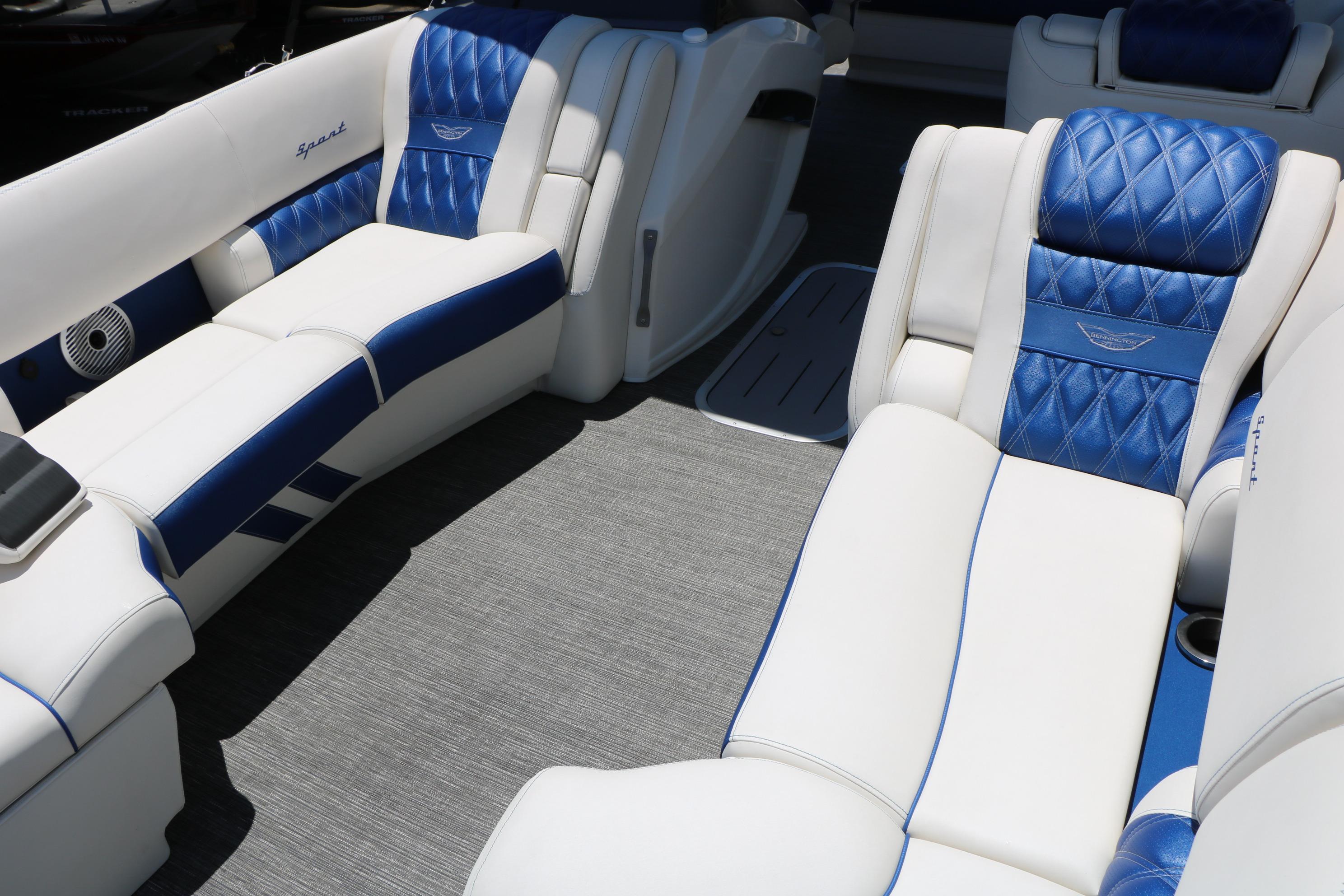 Luxurious interior of 2024 Bennington 23 RX Swingback with blue and white seating.