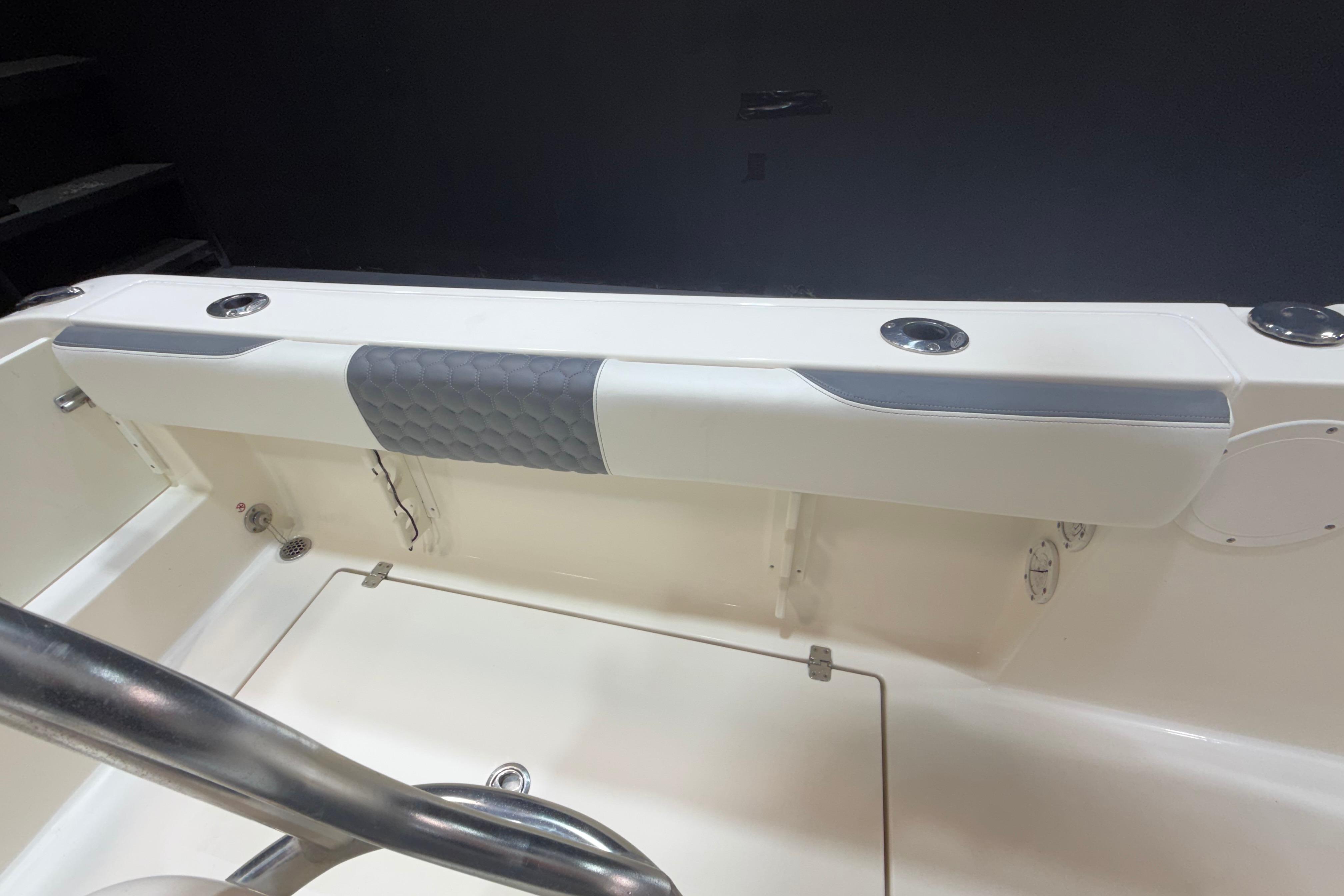 2023 Cobia 237 Center Console boat interior with cushioned seating and stainless steel fixtures.
