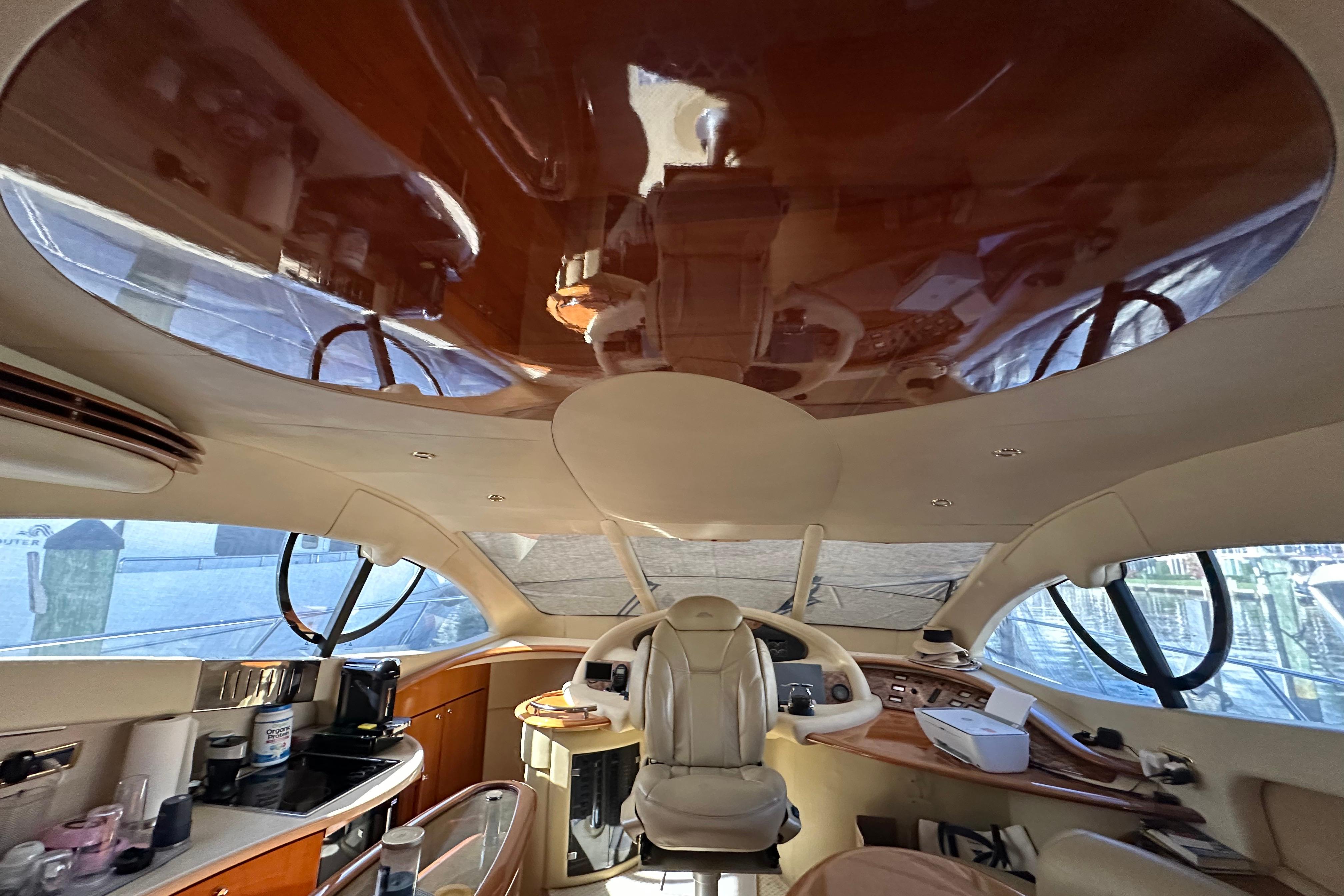 Luxurious interior of a 2004 Azimut 55E yacht with elegant wood finishes.