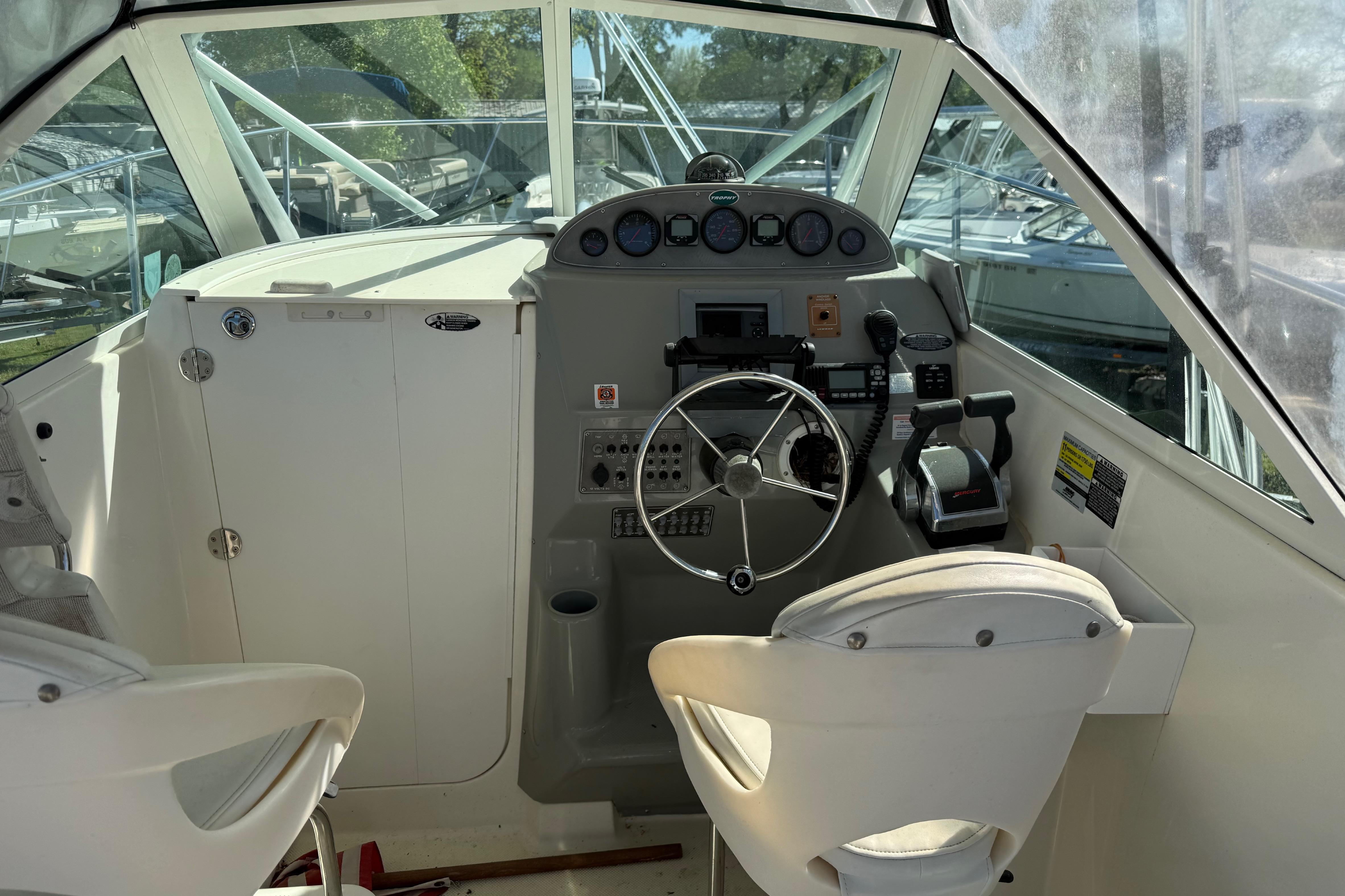 Interior cockpit of a 2006 Trophy 2502 Walkaround boat with steering wheel and controls.