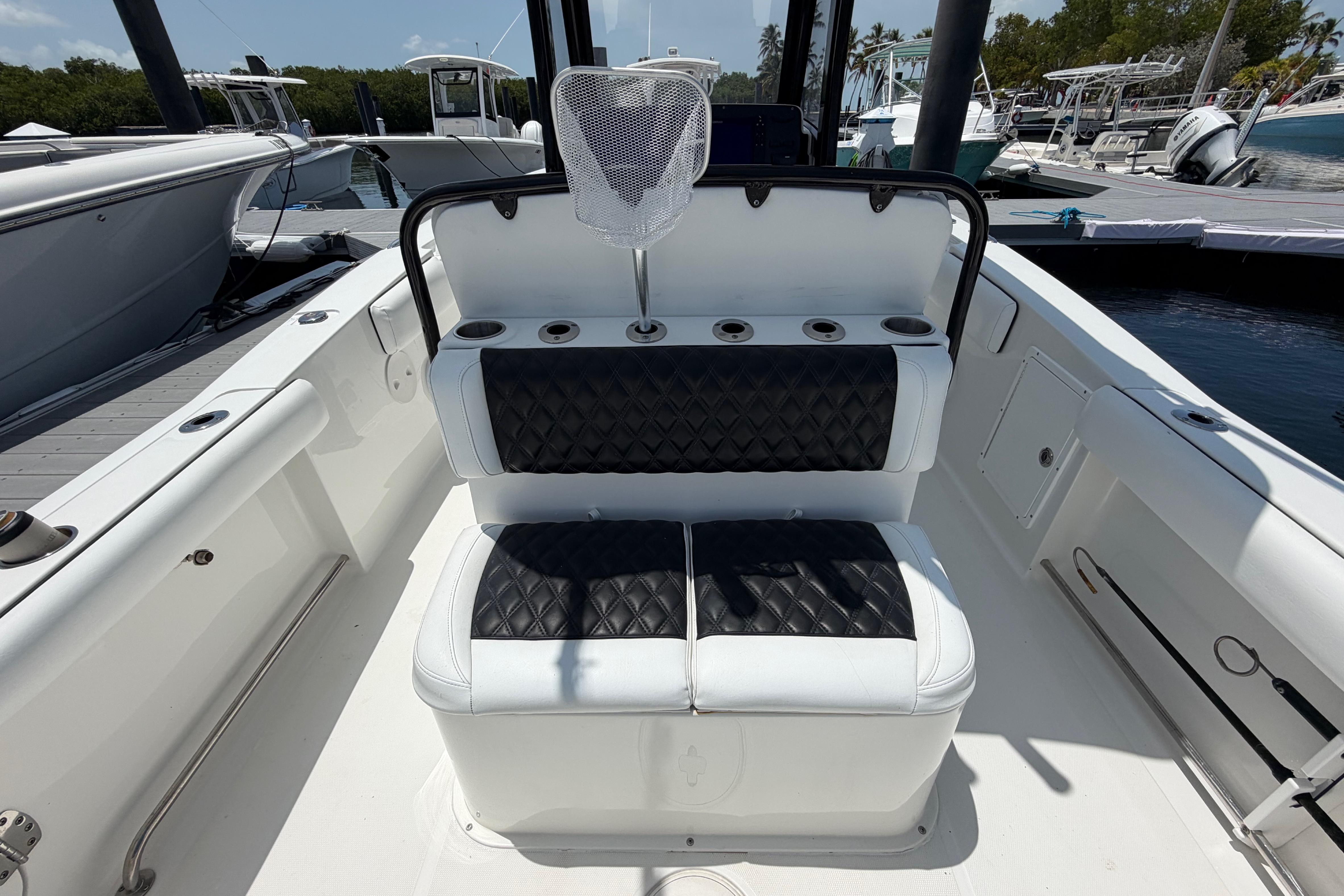 2019 Sea Hunt Gamefish 27 Coffin Box boat interior with cushioned seating and rod holders.