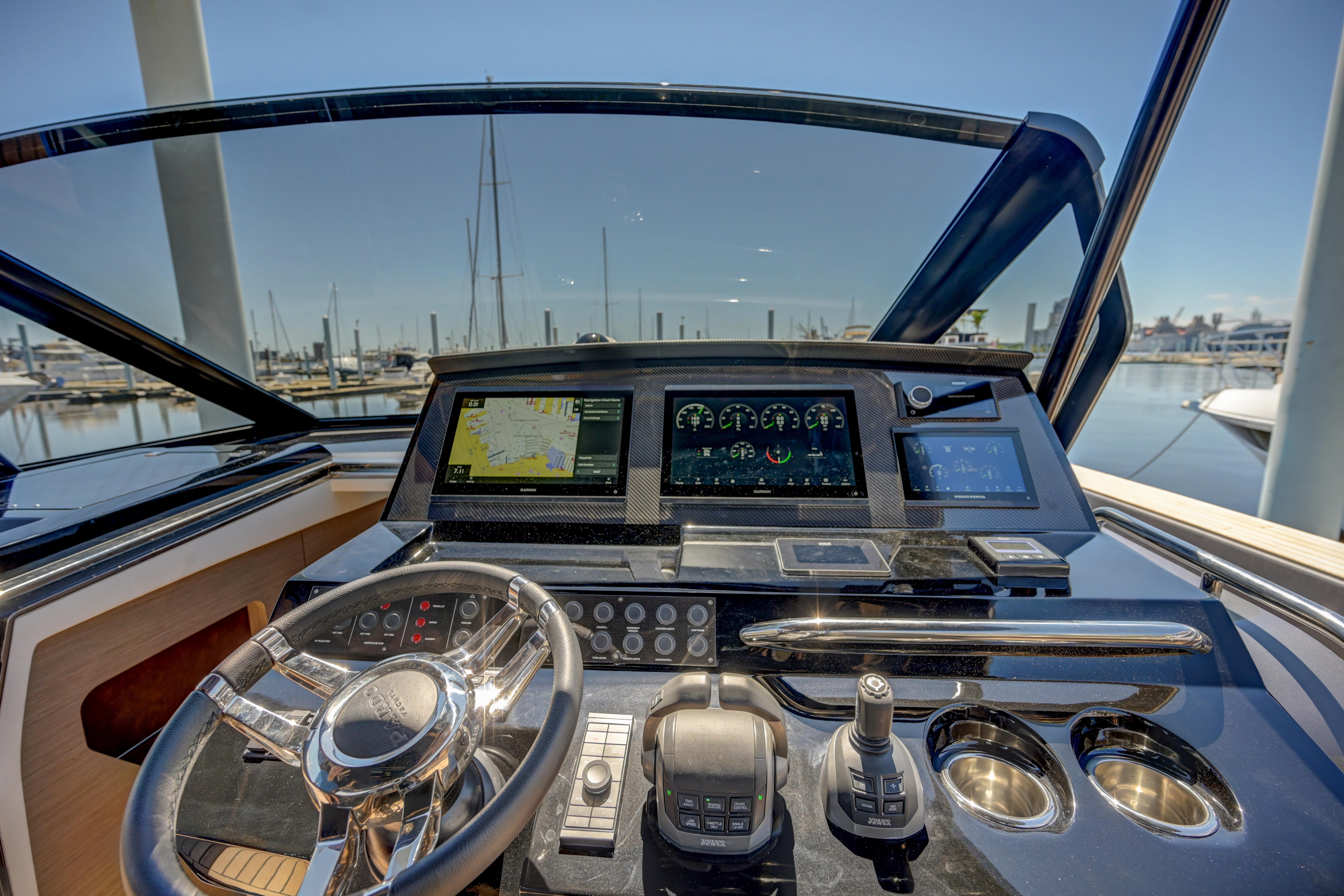 Helm of 2025 Pardo Yachts 50 with advanced navigation systems and marina view.