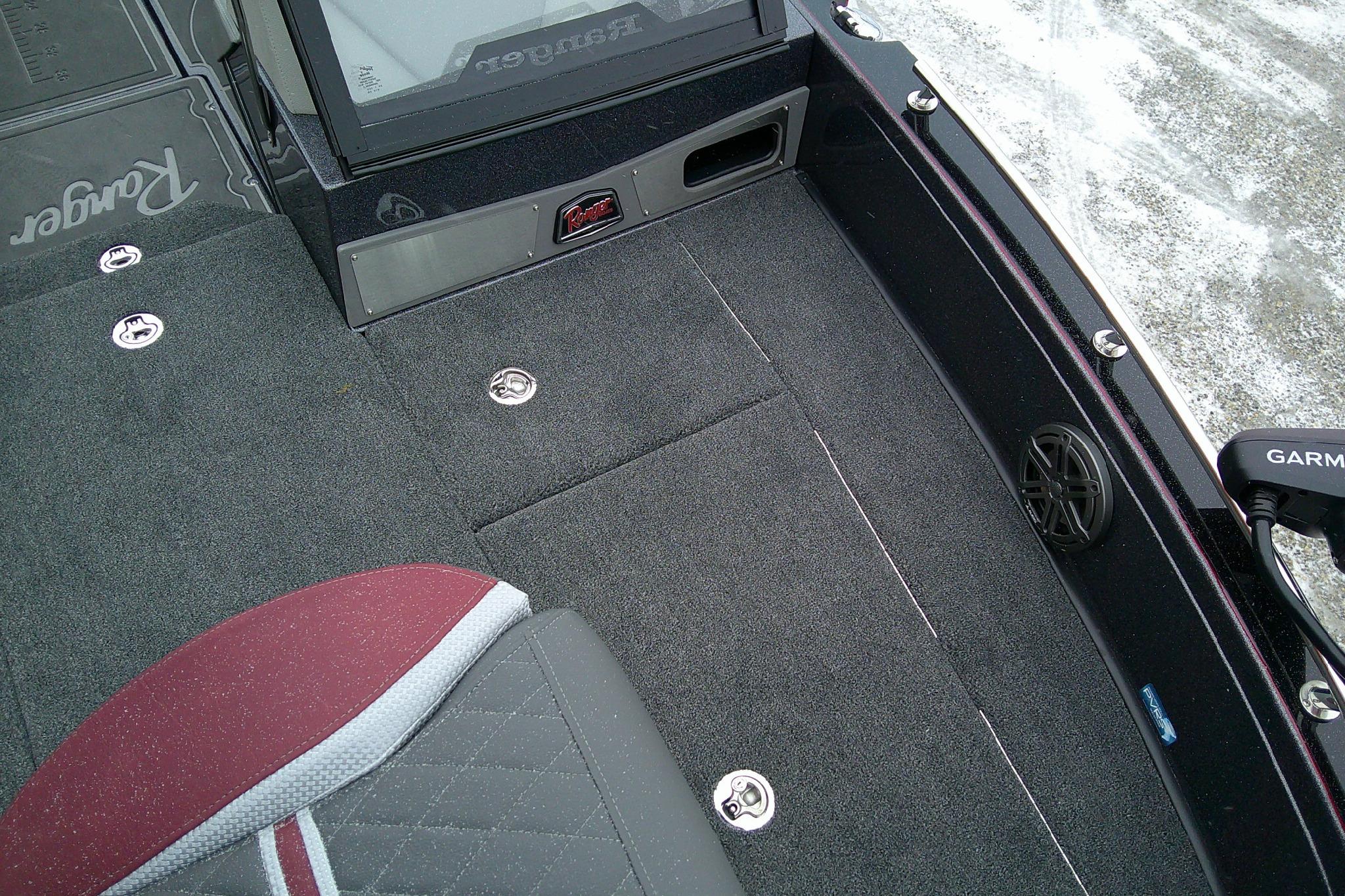 2026 Ranger 620xFS Pro boat interior with carpeted deck and seating.