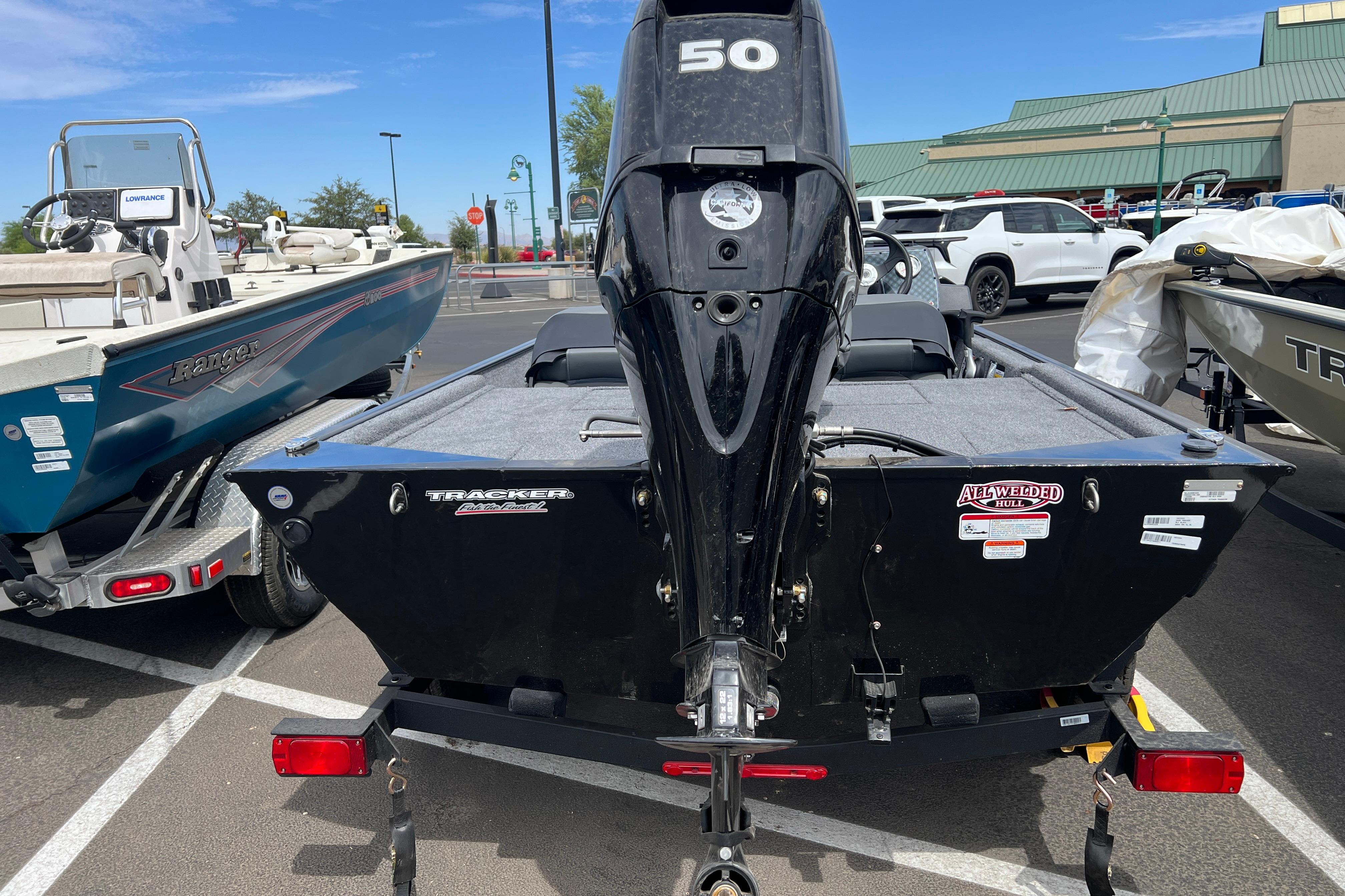 2026 Tracker Bass Tracker Classic XL boat with a 50 HP engine in a parking lot.