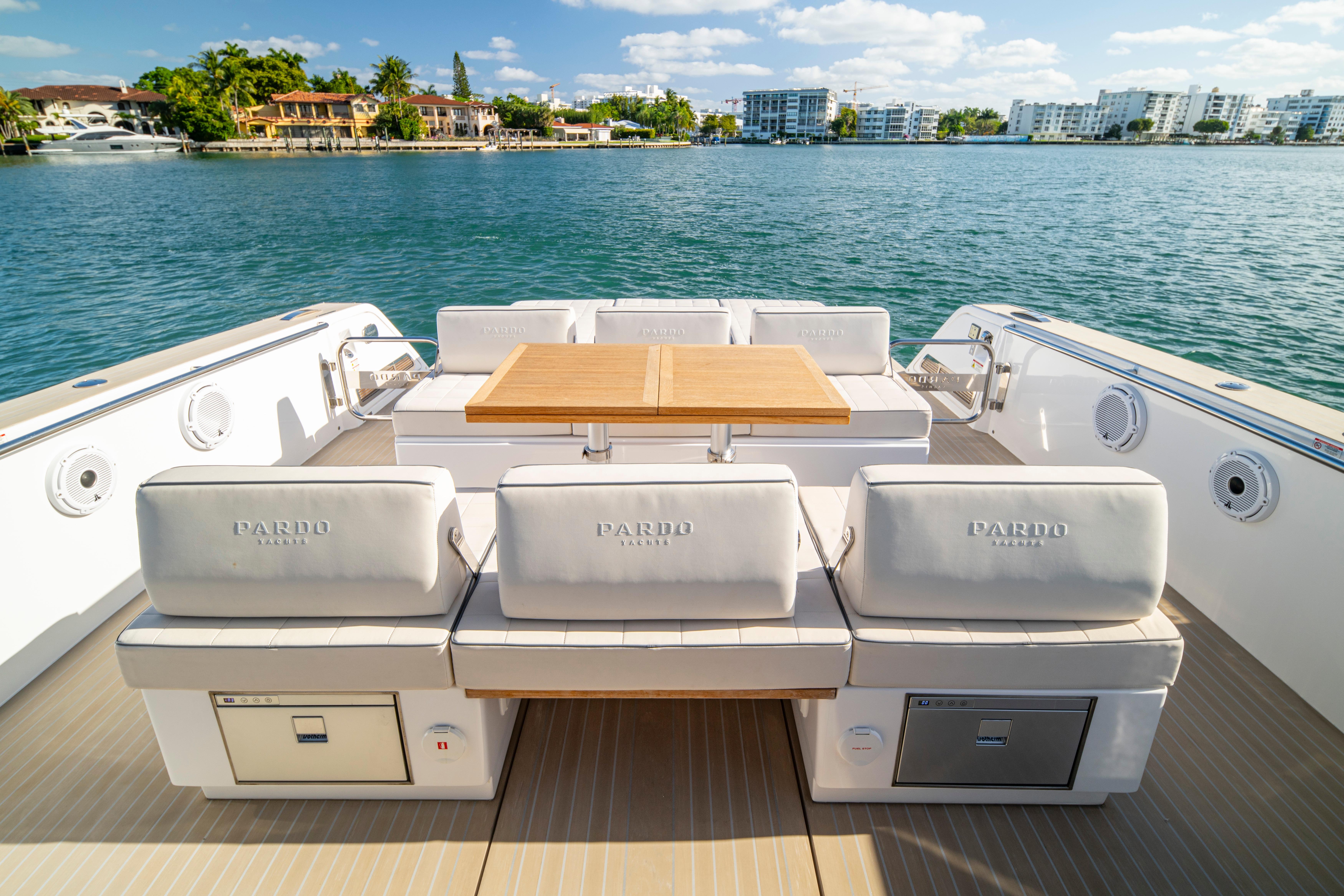 2024 Pardo Yachts P43 luxury yacht deck with seating and table, overlooking serene waters.