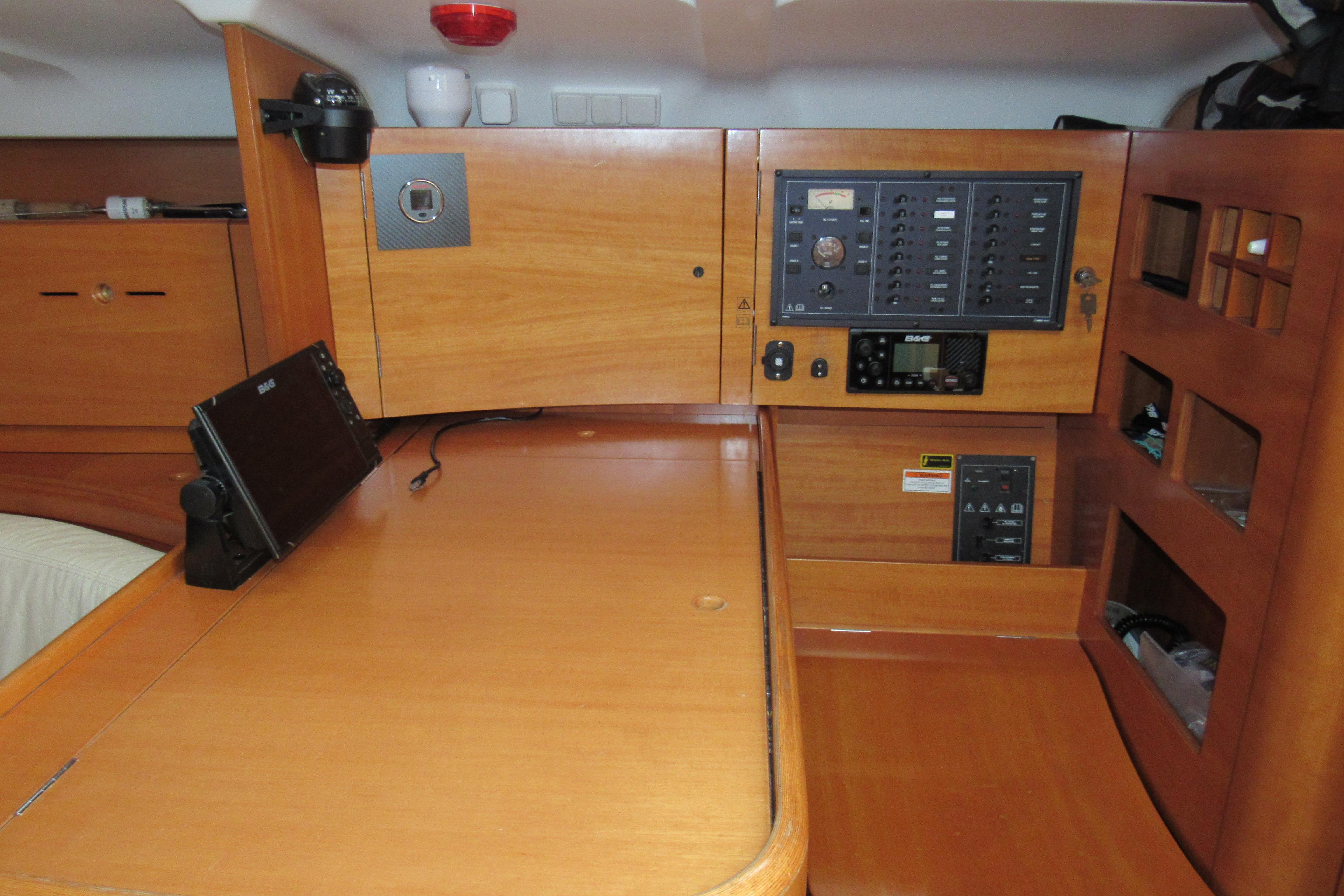 Interior of 2002 Beneteau First 40.7 yacht with navigation equipment and control panel.