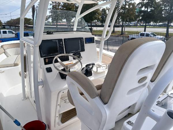 2015 Sea Fox 286 Commander boat cockpit with steering wheel and navigation screens.