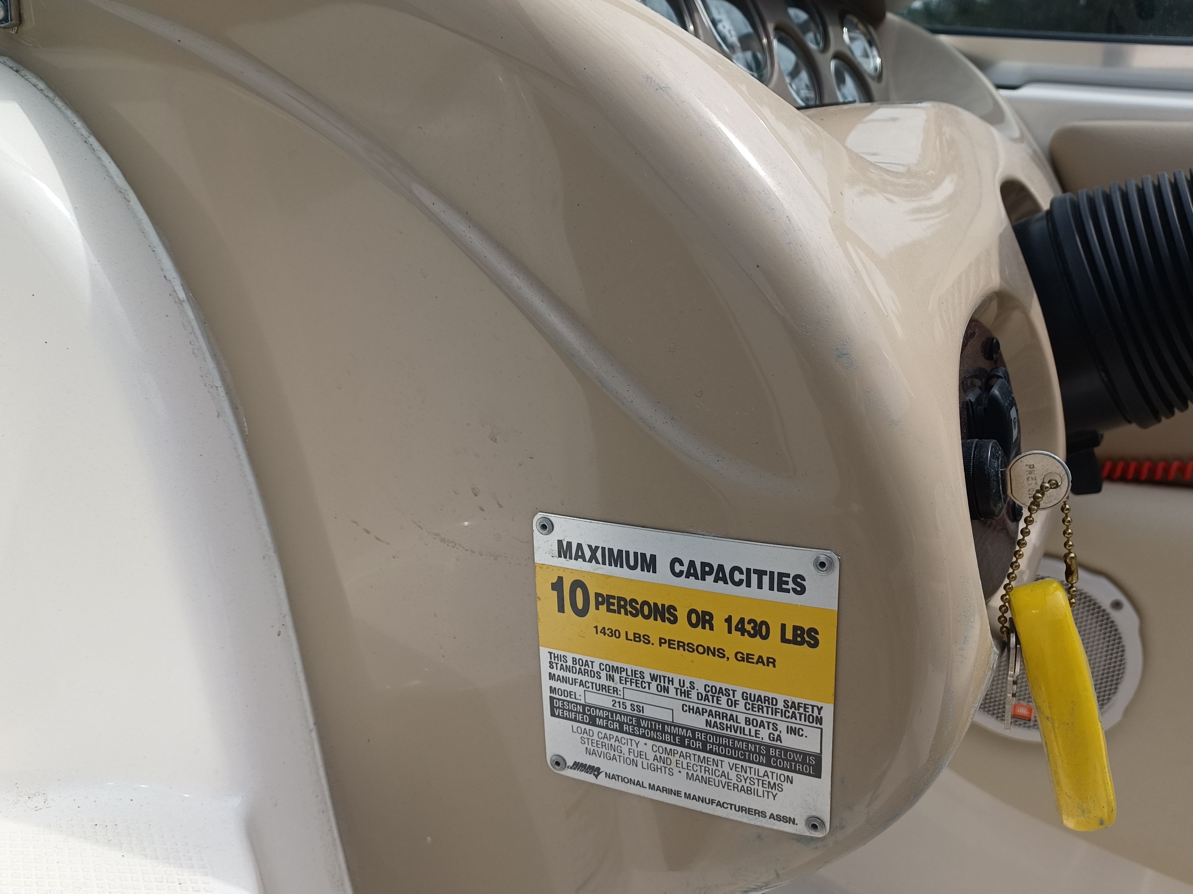 Close-up of a 2004 Chaparral 215 SSi helm with capacity label.