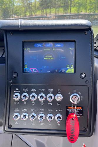 2024 Moomba Max dashboard with touchscreen and control panel, featuring various switches and a red key tag.