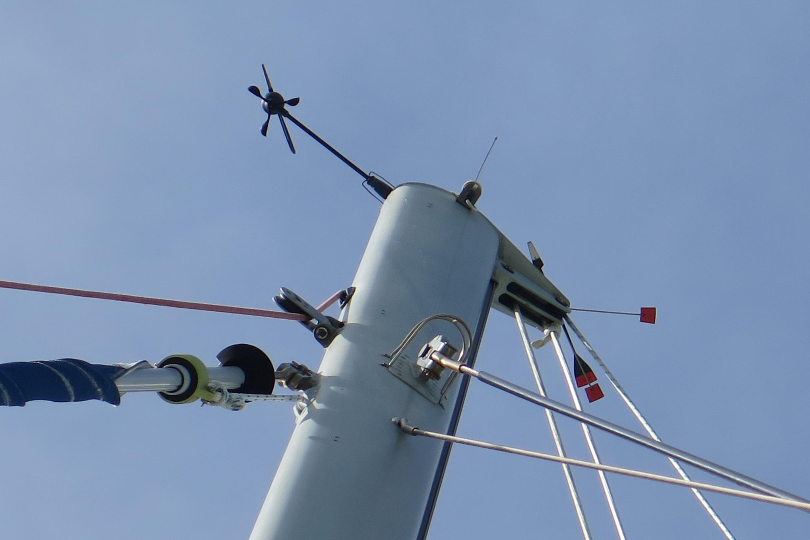 Mast of 2009 Leopard 46 sailboat with rigging and wind instruments against clear sky.