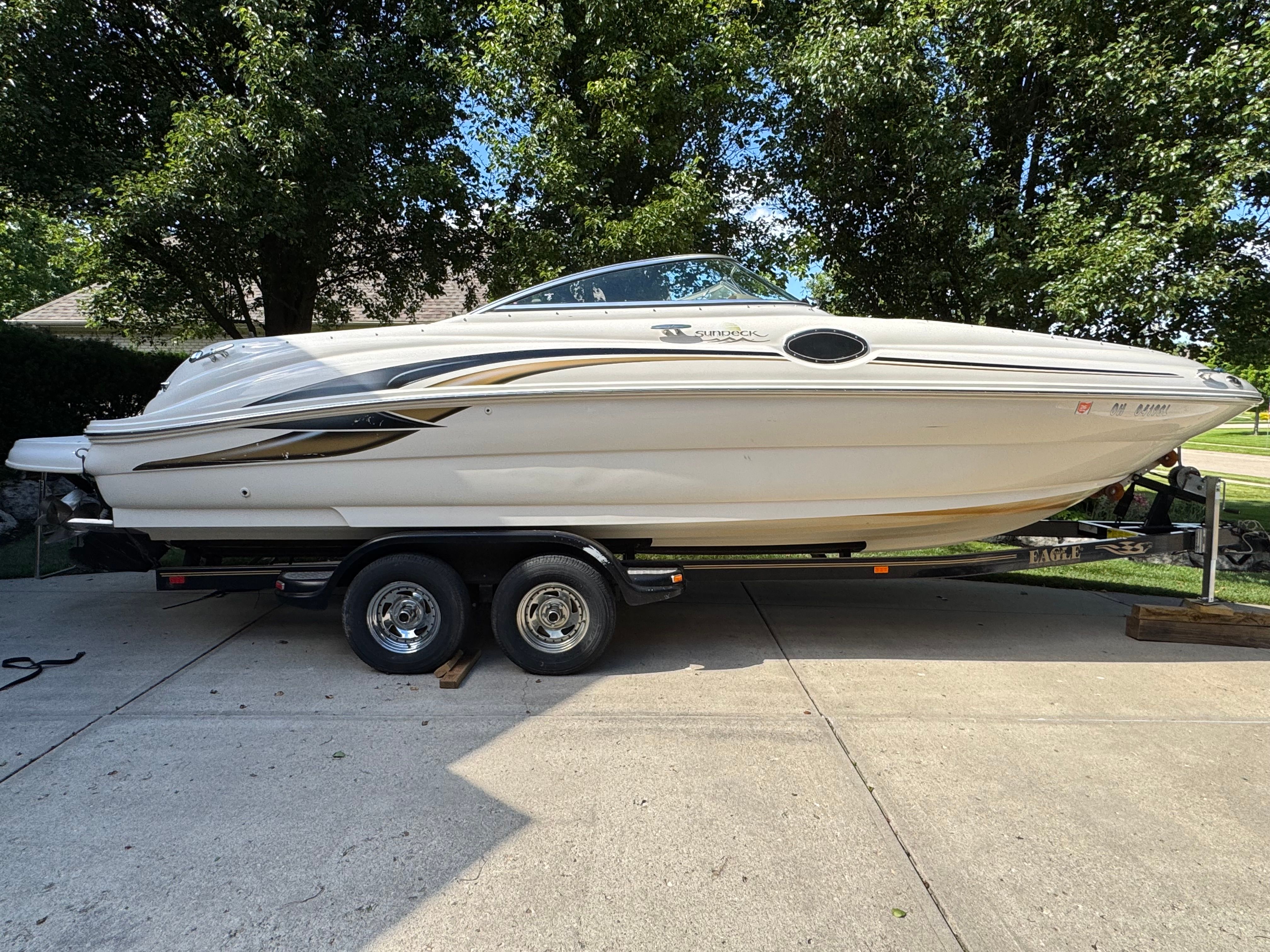 2001 Sea Ray 240 Sundeck parked on trailer outdoors.