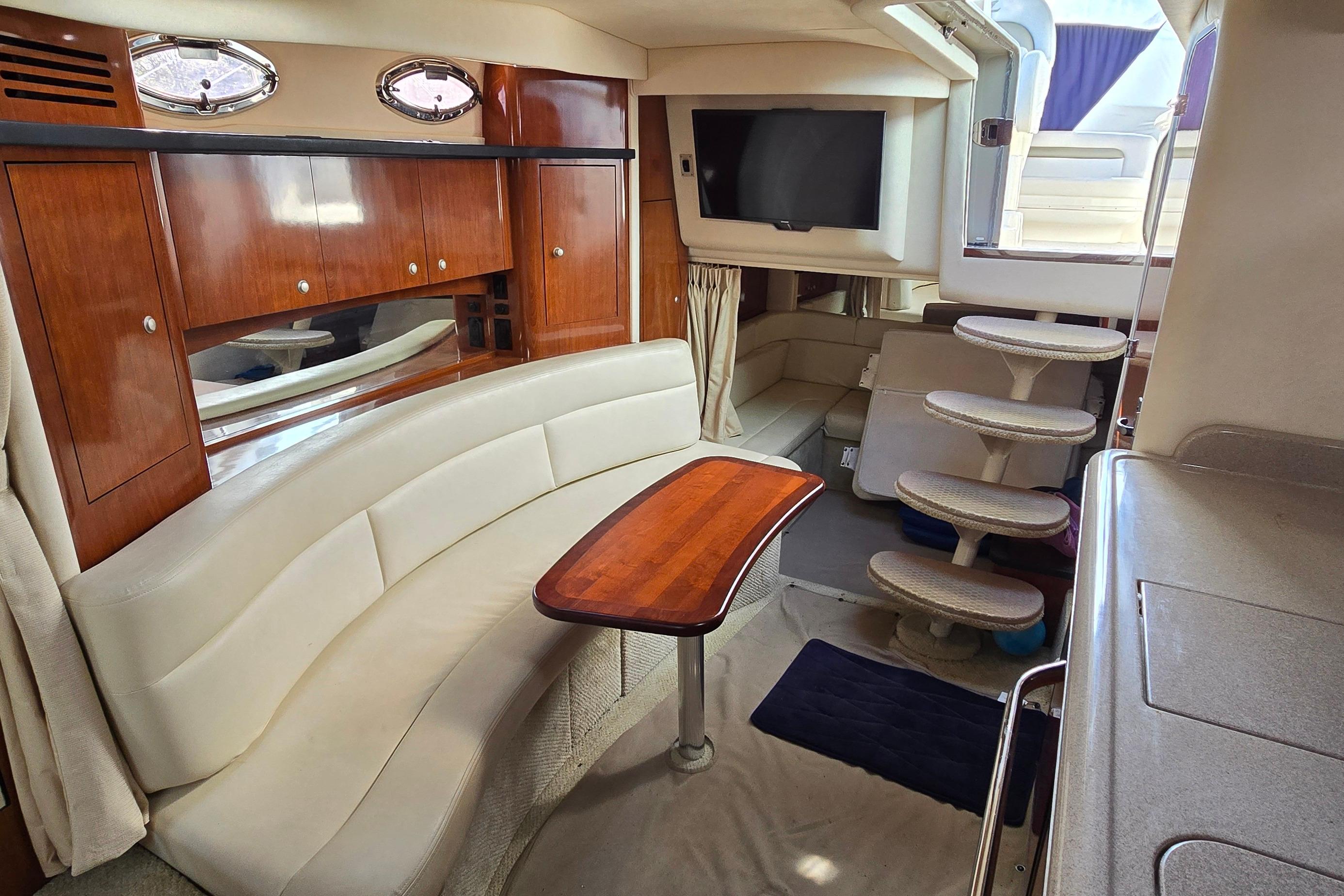 2007 Sea Ray 340 Sundancer interior with elegant seating, wooden table, and modern amenities.