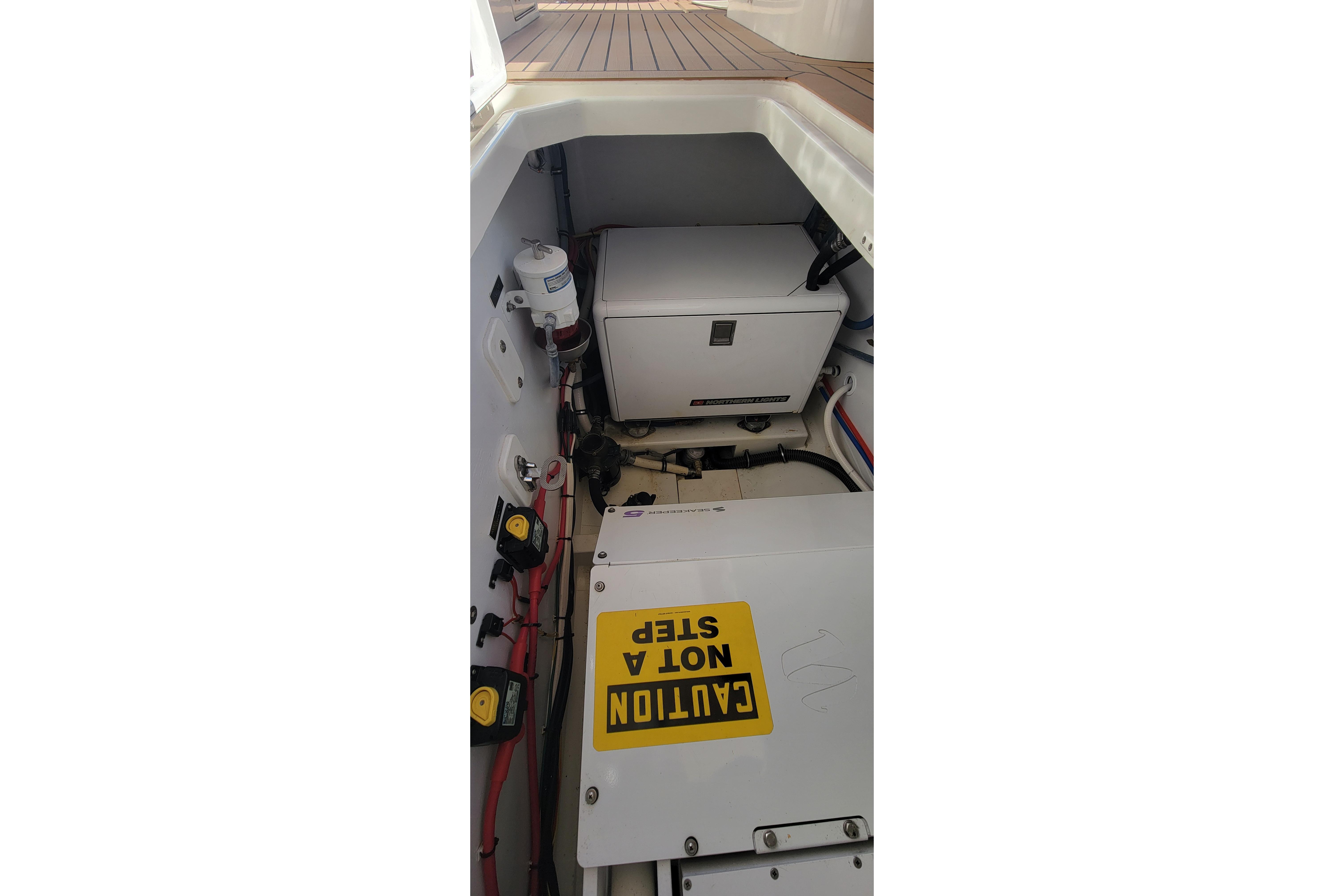 Engine compartment of 2017 MJM 40z Downeast boat with caution sign.