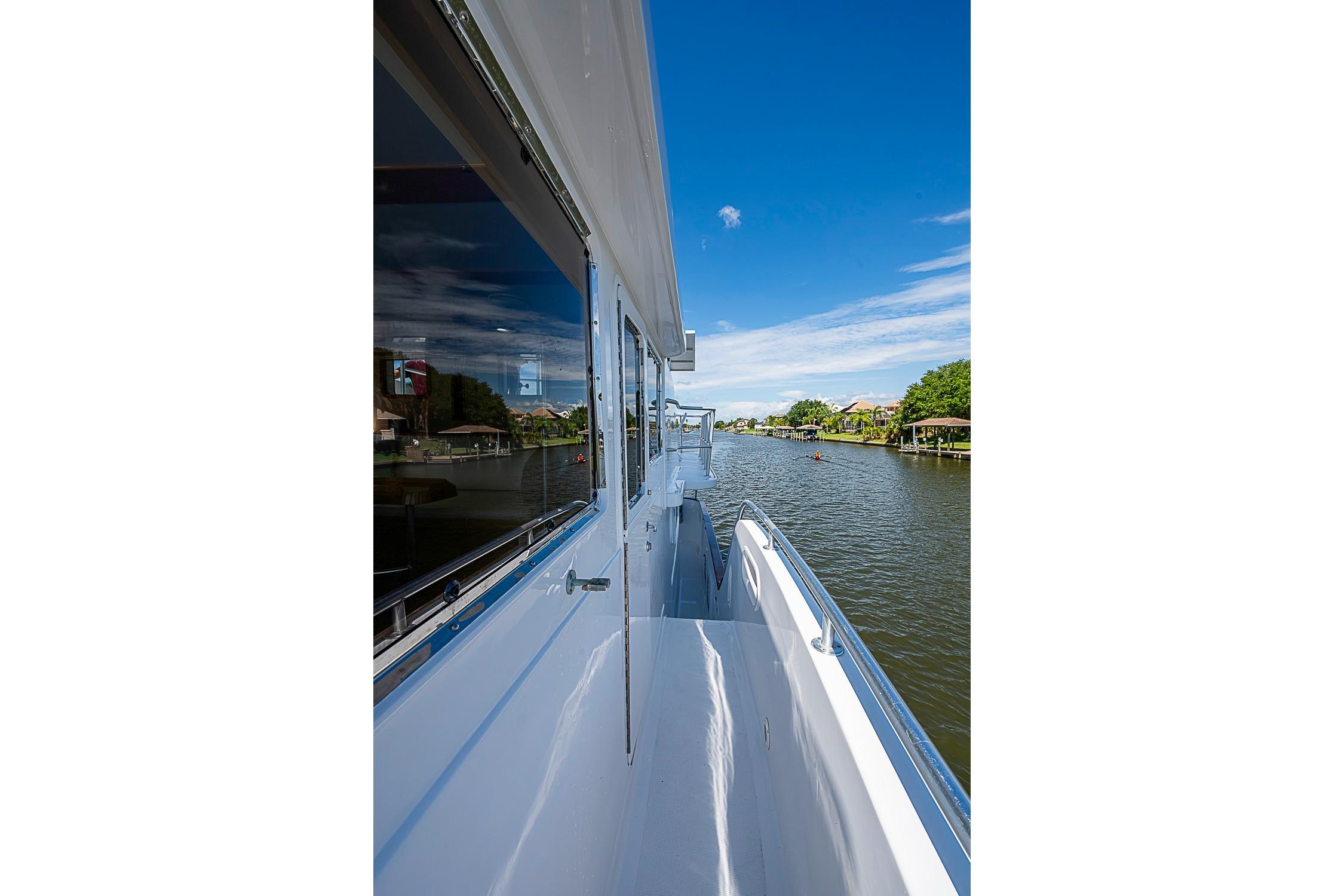 Side view of 2003 Magna Marine Nova Scotia 47 yacht on a serene river.