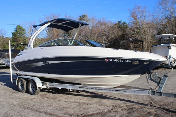 2016 Sea Ray 240 Sundeck boat on trailer, parked outdoors.