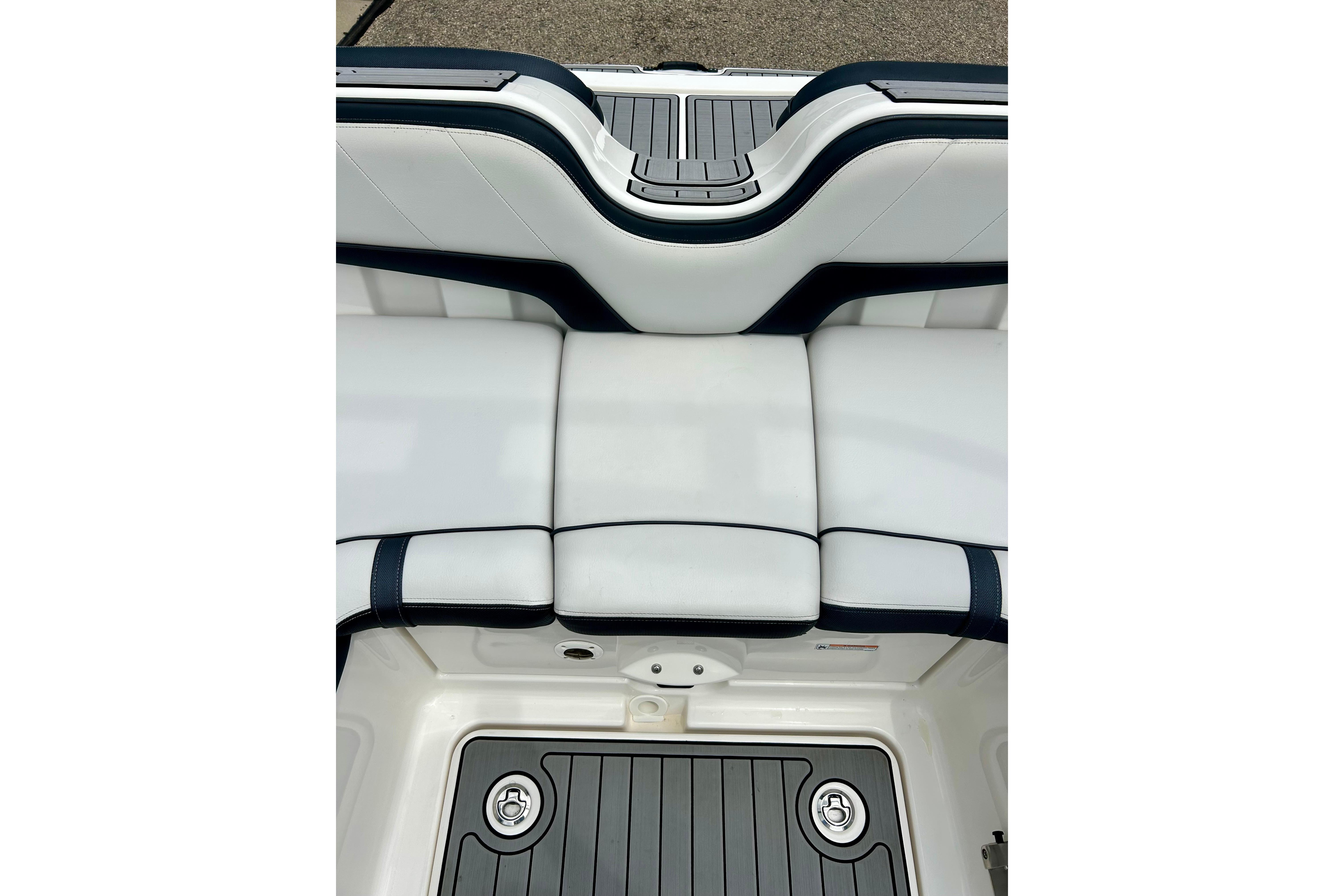 2015 Yamaha Boats AR210 interior seating and deck detail, featuring sleek white and black design.