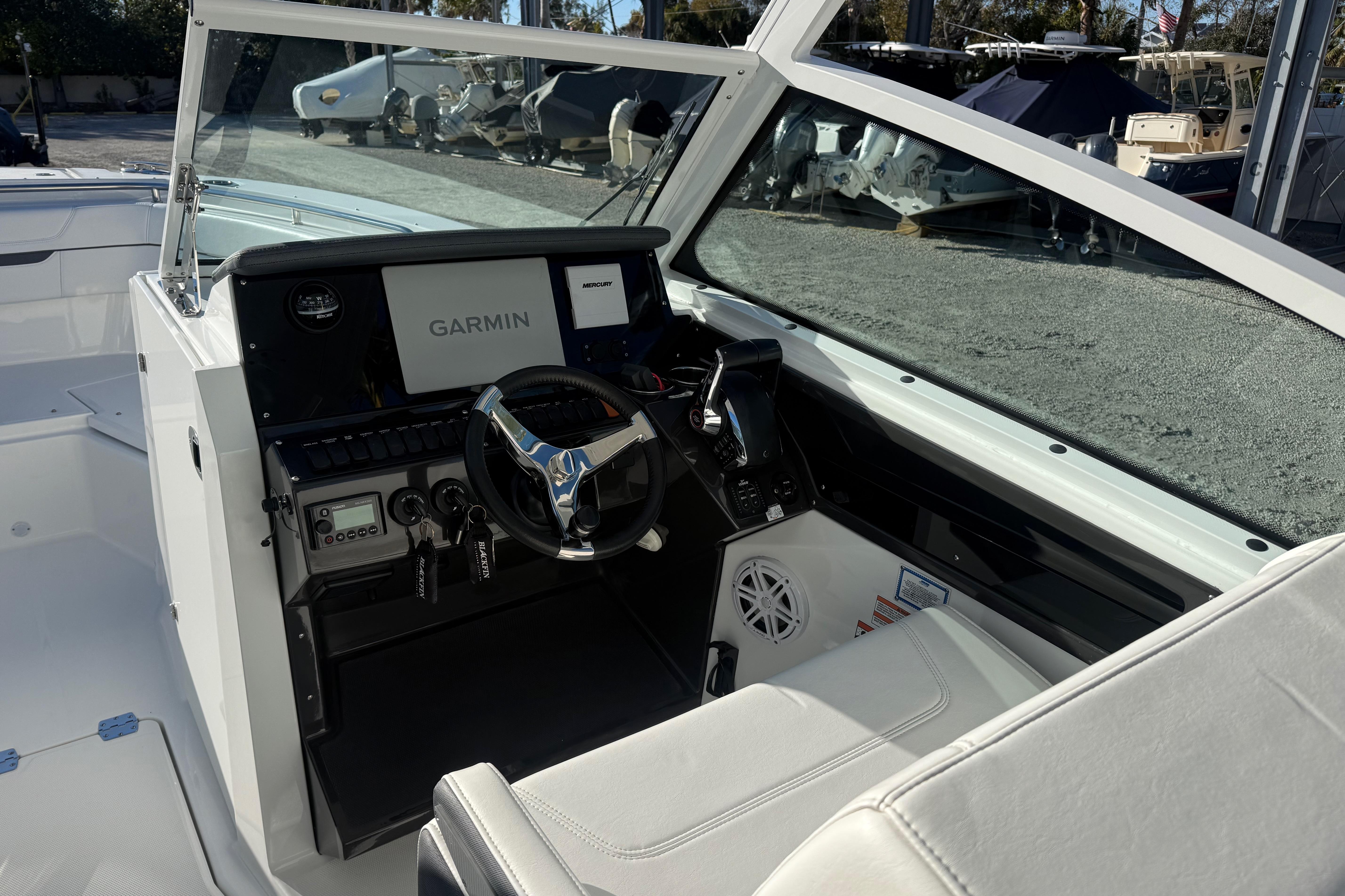 2022 Blackfin 272 DC boat cockpit with Garmin navigation system and steering wheel.