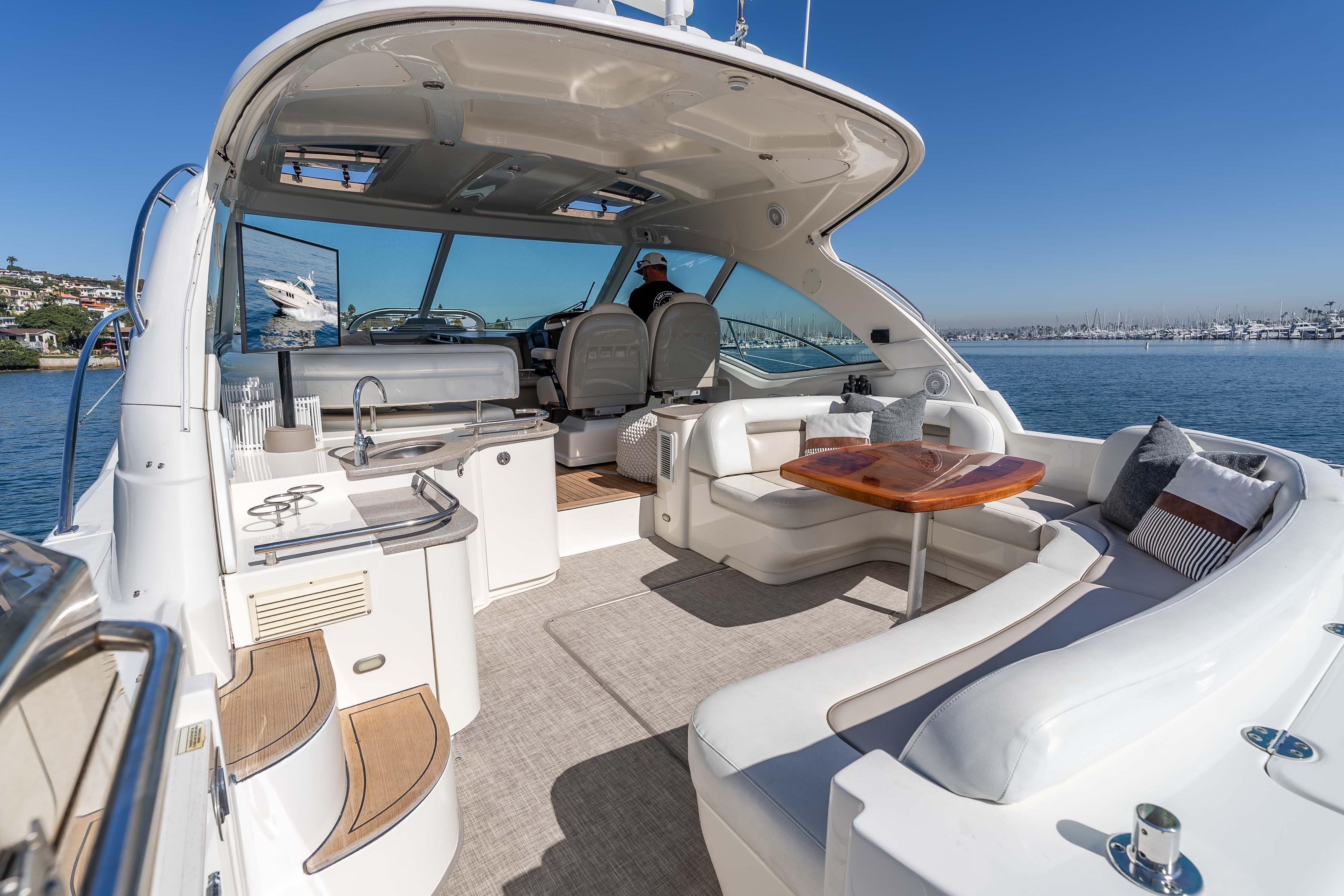 Luxurious 2007 Sea Ray 48 Sundancer yacht interior with elegant seating and scenic ocean view.