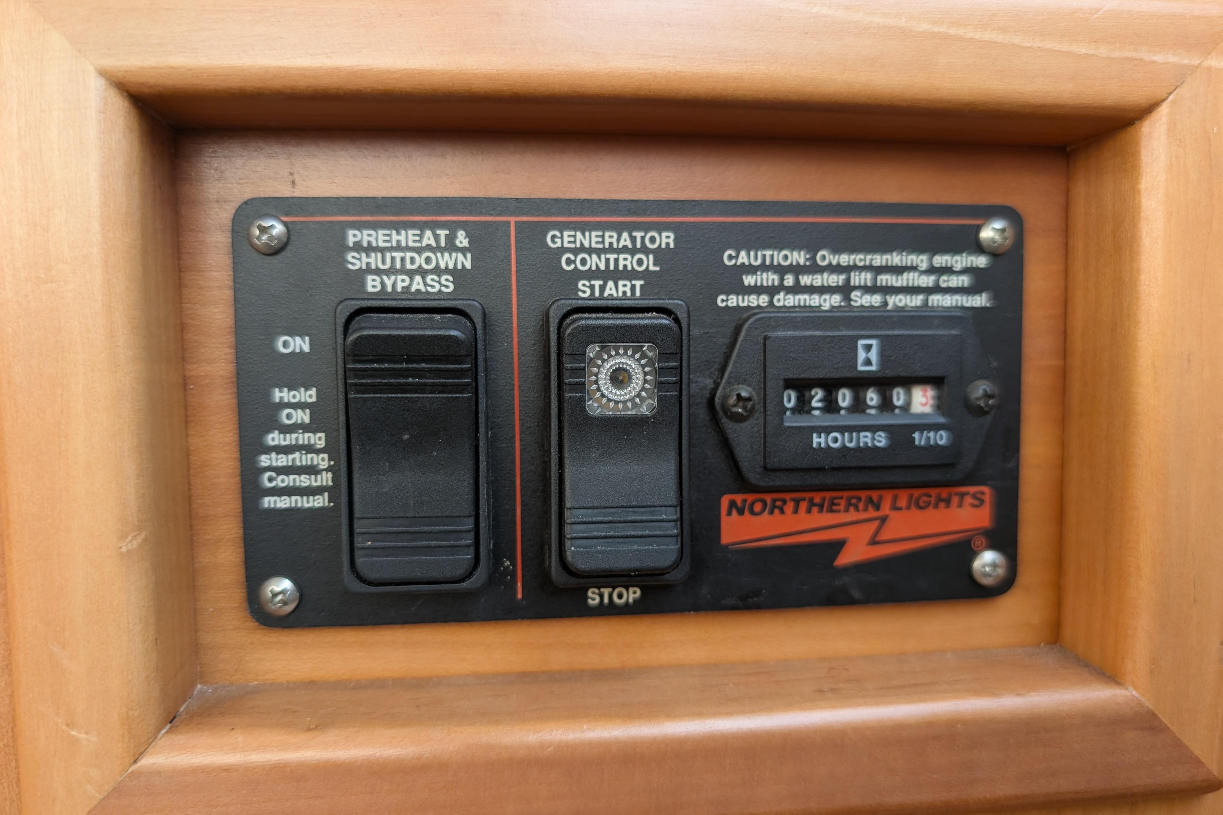 Control panel of a 2004 PDQ 34 Powercat with generator start and hour meter.
