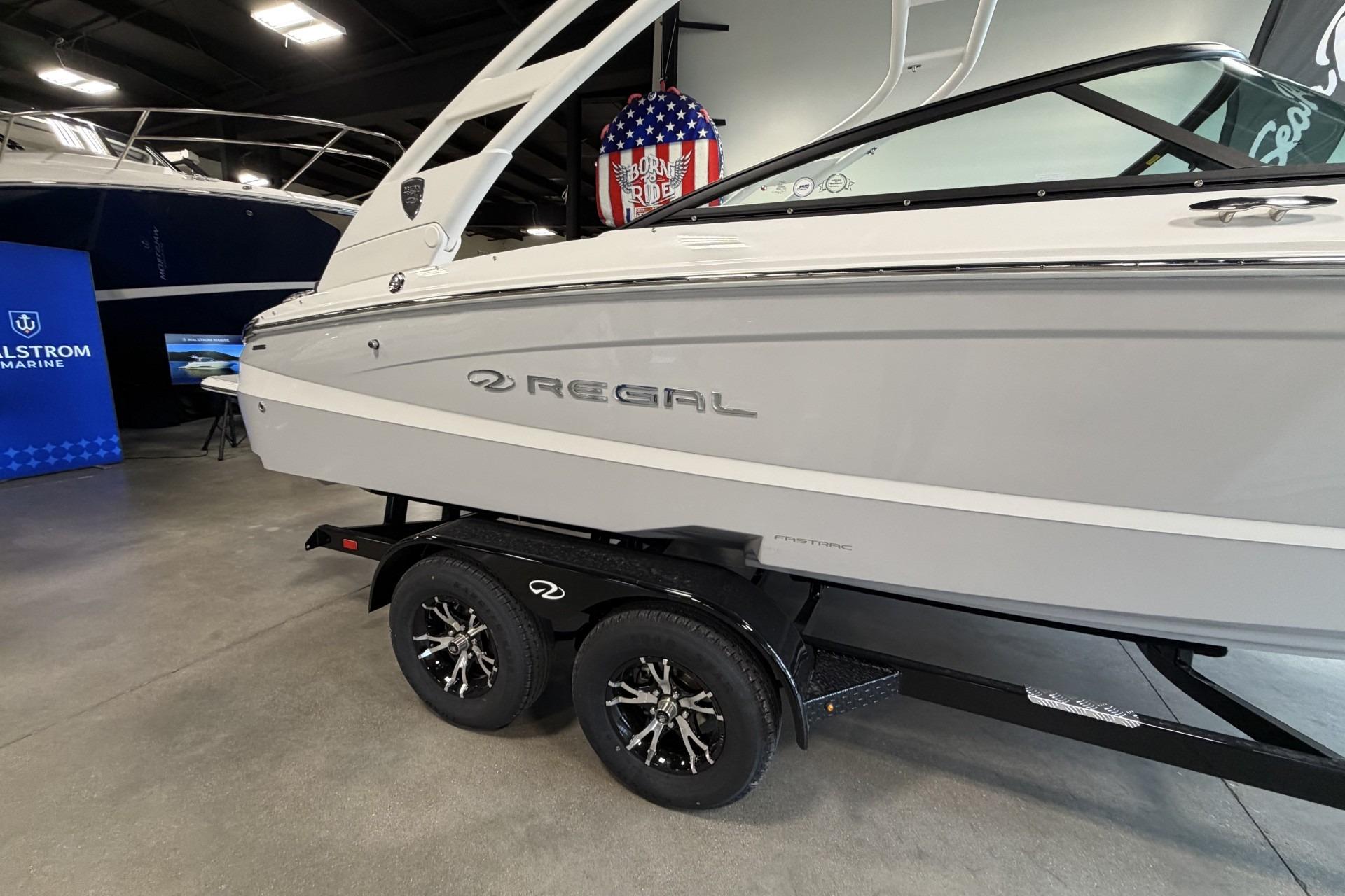 2027 Regal LS2 boat on trailer in showroom, featuring sleek design and modern aesthetics.