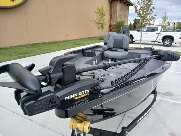 2025 Tracker Super Guide V-16 T boat with Minn Kota PowerDrive motor in parking lot.