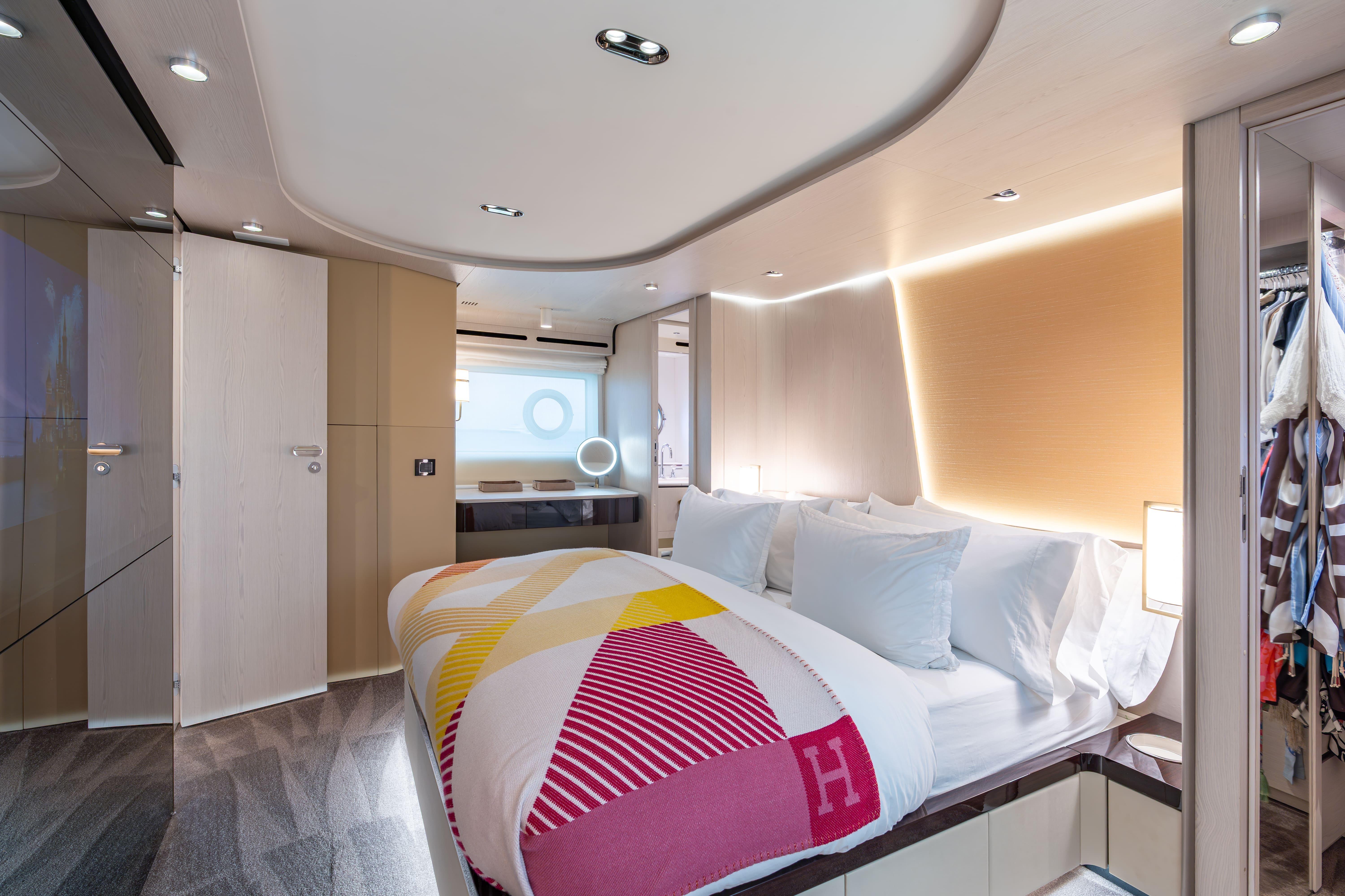 Luxurious bedroom interior of 2022 Azimut 78 yacht, featuring modern design and elegant lighting.