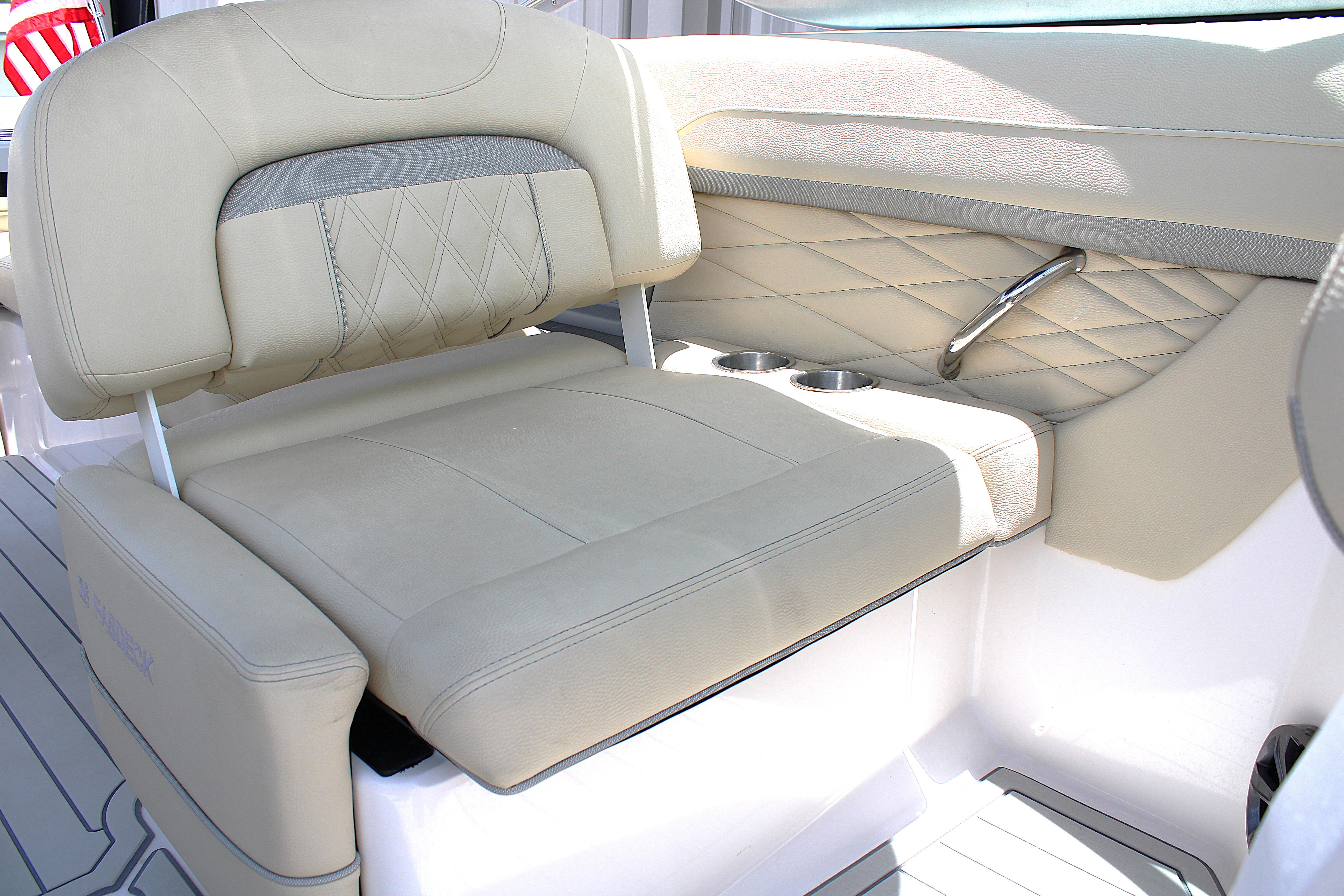 Luxurious beige seating on 2021 Regal 26 OBX boat with cup holders and quilted design.