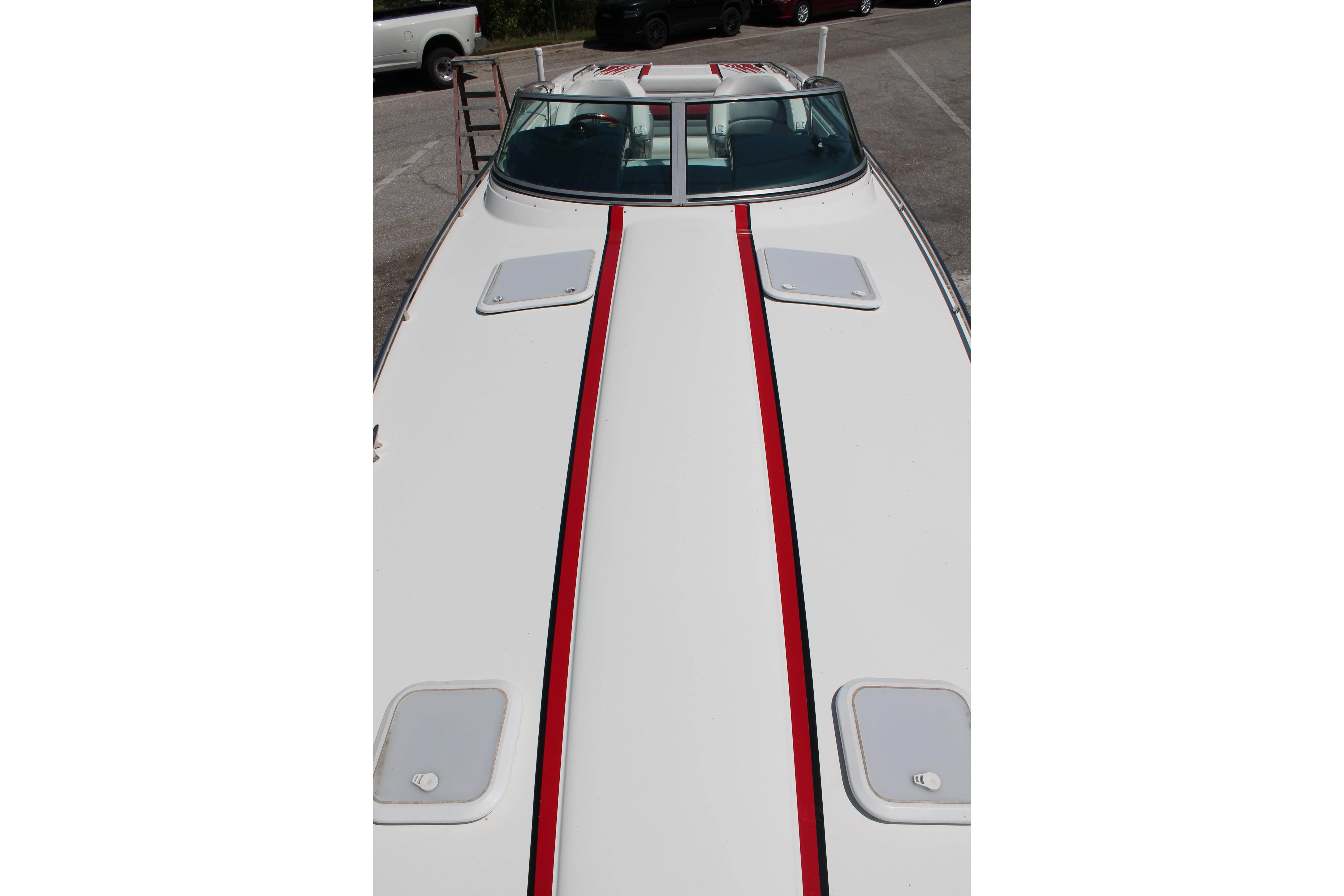 2016 Formula 353 FASTech boat with red stripe on deck, parked in a lot.