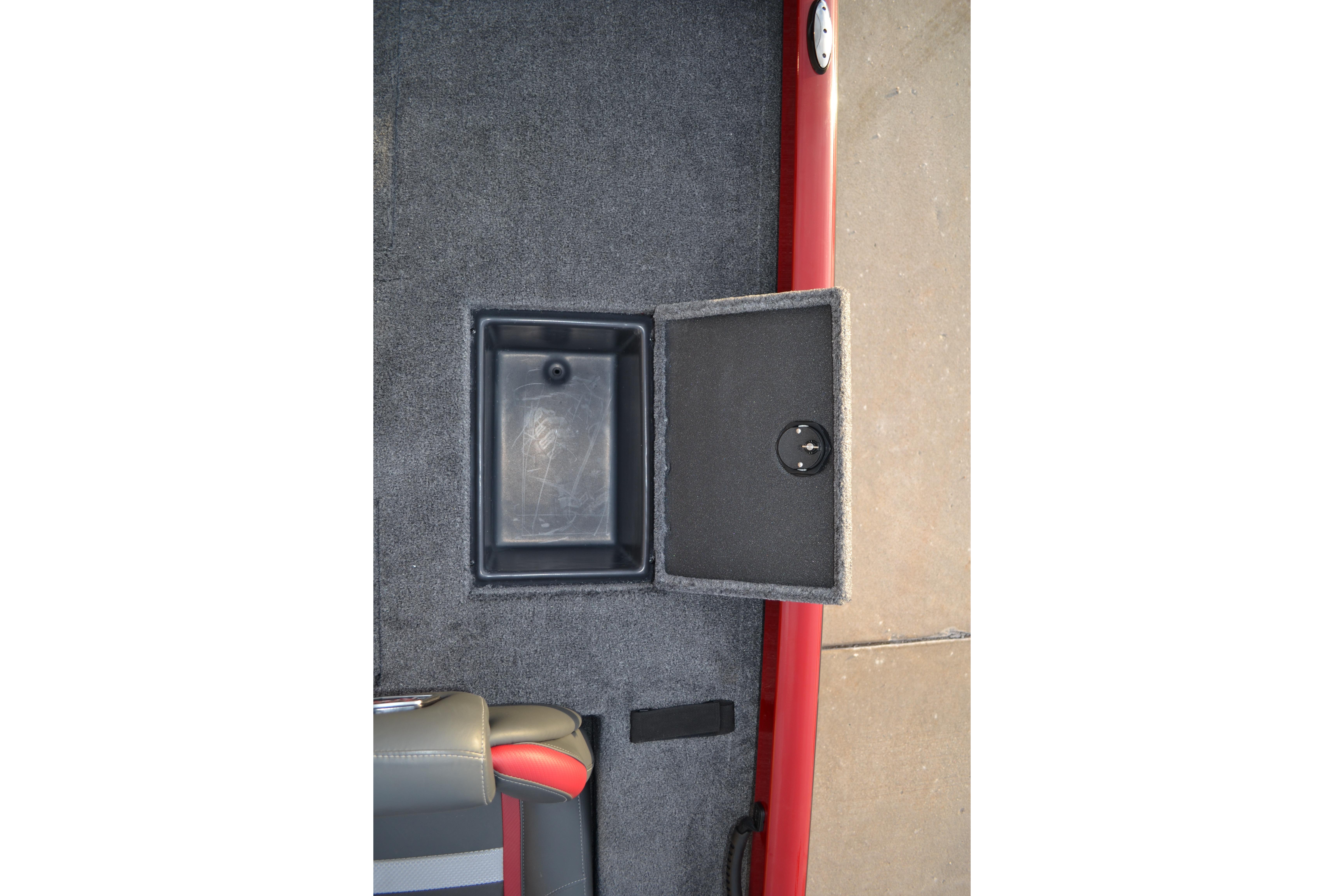 Open storage compartment in 2026 Ranger RT188 boat, featuring carpeted interior and red trim.