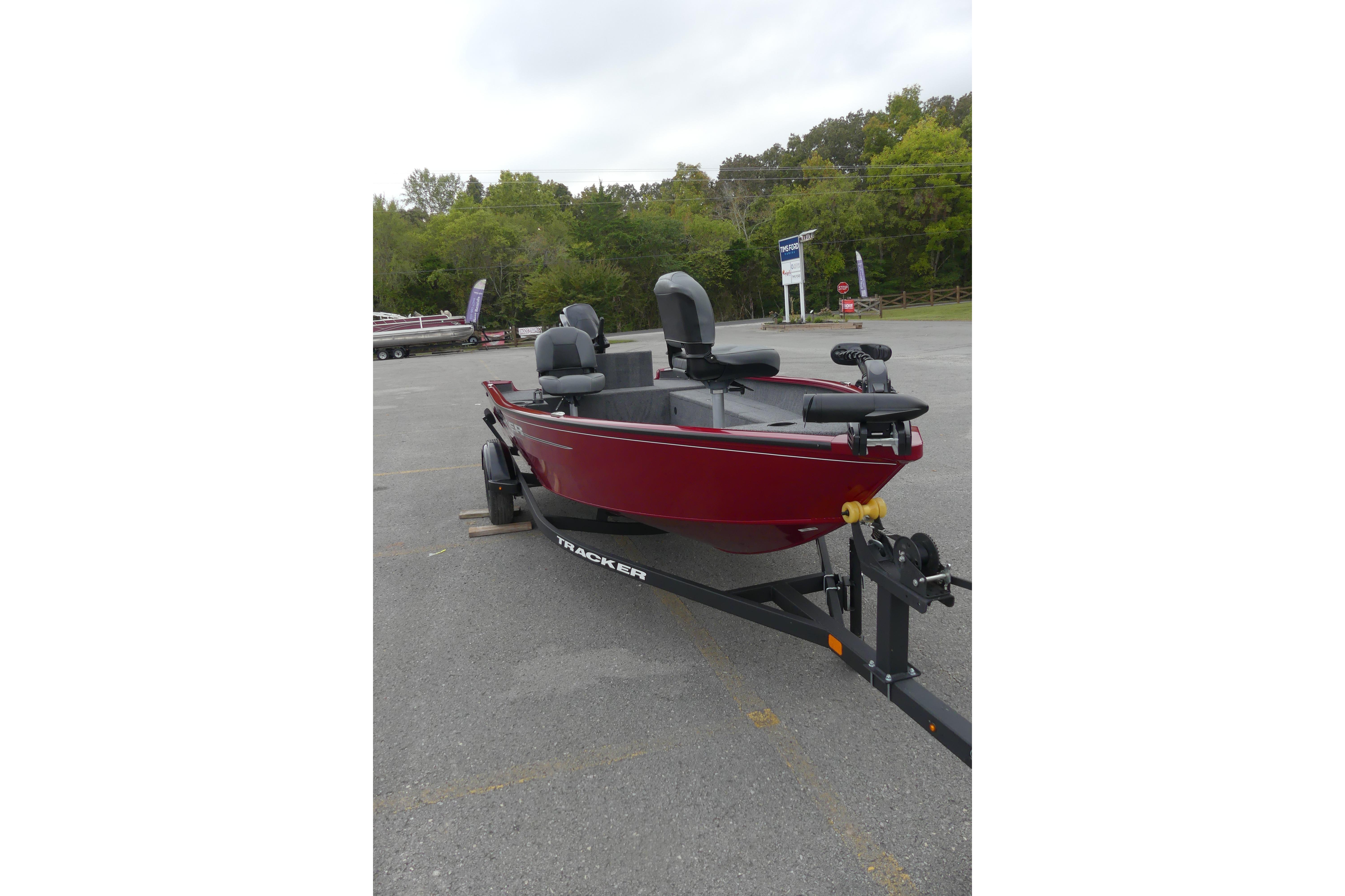 2025 Tracker Super Guide V-16 T boat on trailer in parking lot.