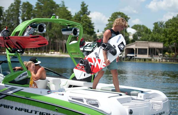 Manufacturer Provided Image: 2013 Nautique Super Air Nautique 230 with wakeboarders on a lake.