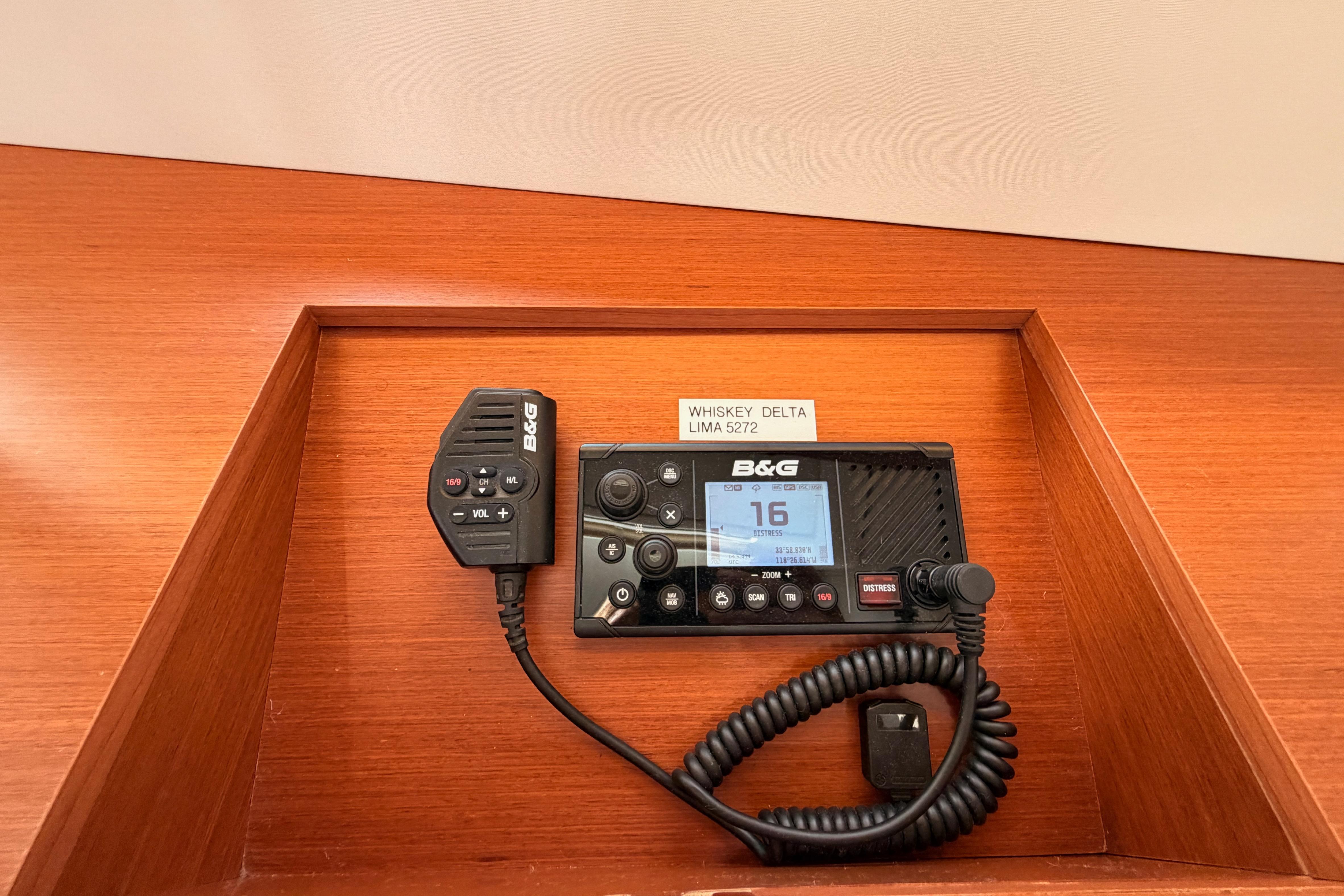 B&G marine radio on 2020 Beneteau Oceanis 46.1 yacht, wooden panel background.