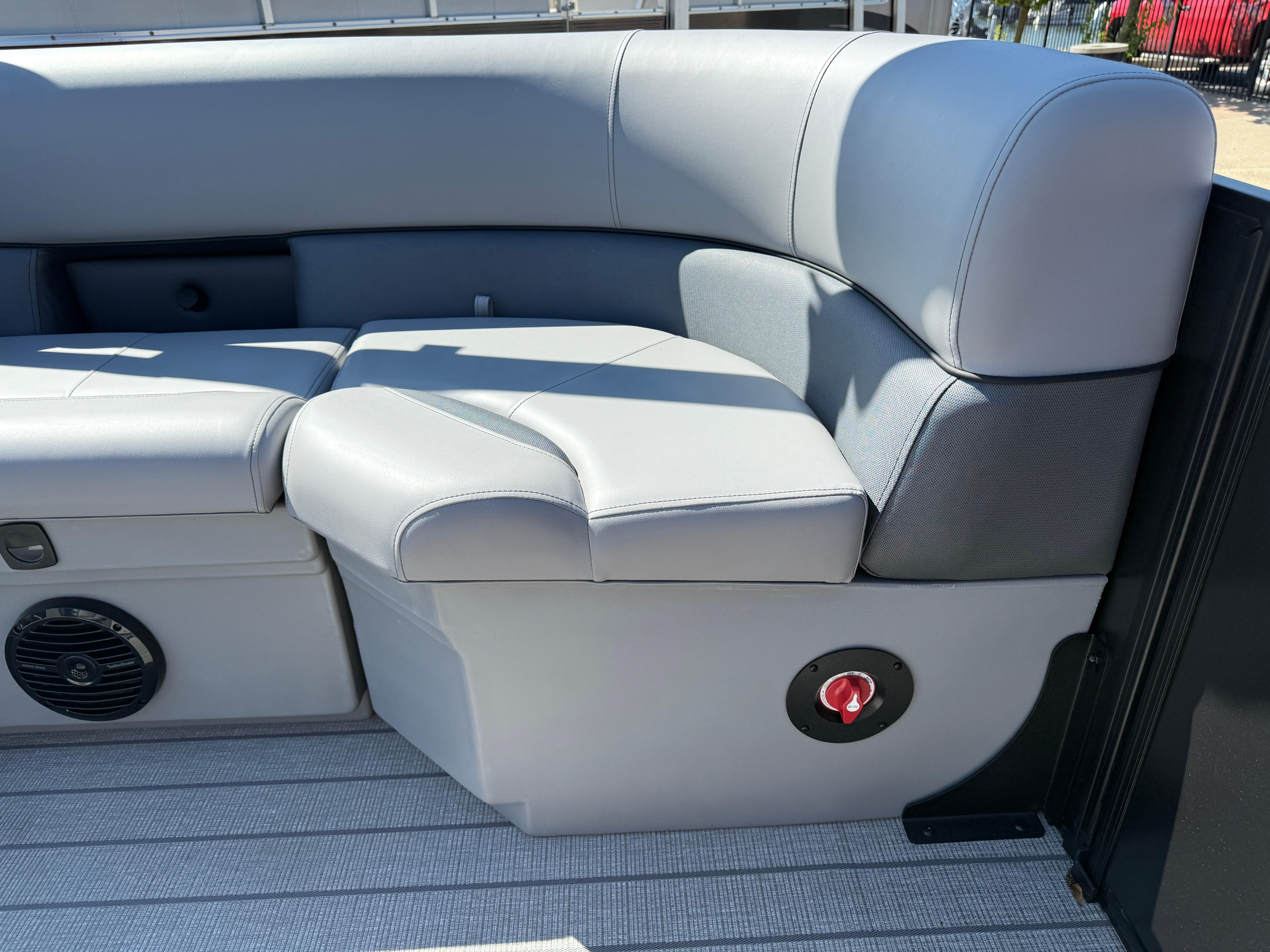 2026 Bentley Pontoons Legacy 223 Navigator interior seating with gray upholstery and speaker.