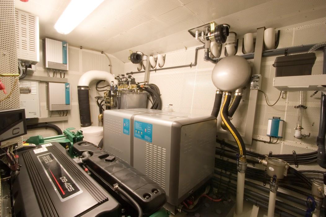 Engine room of a 2008 Pacific Prestige 200 yacht, featuring various mechanical components.