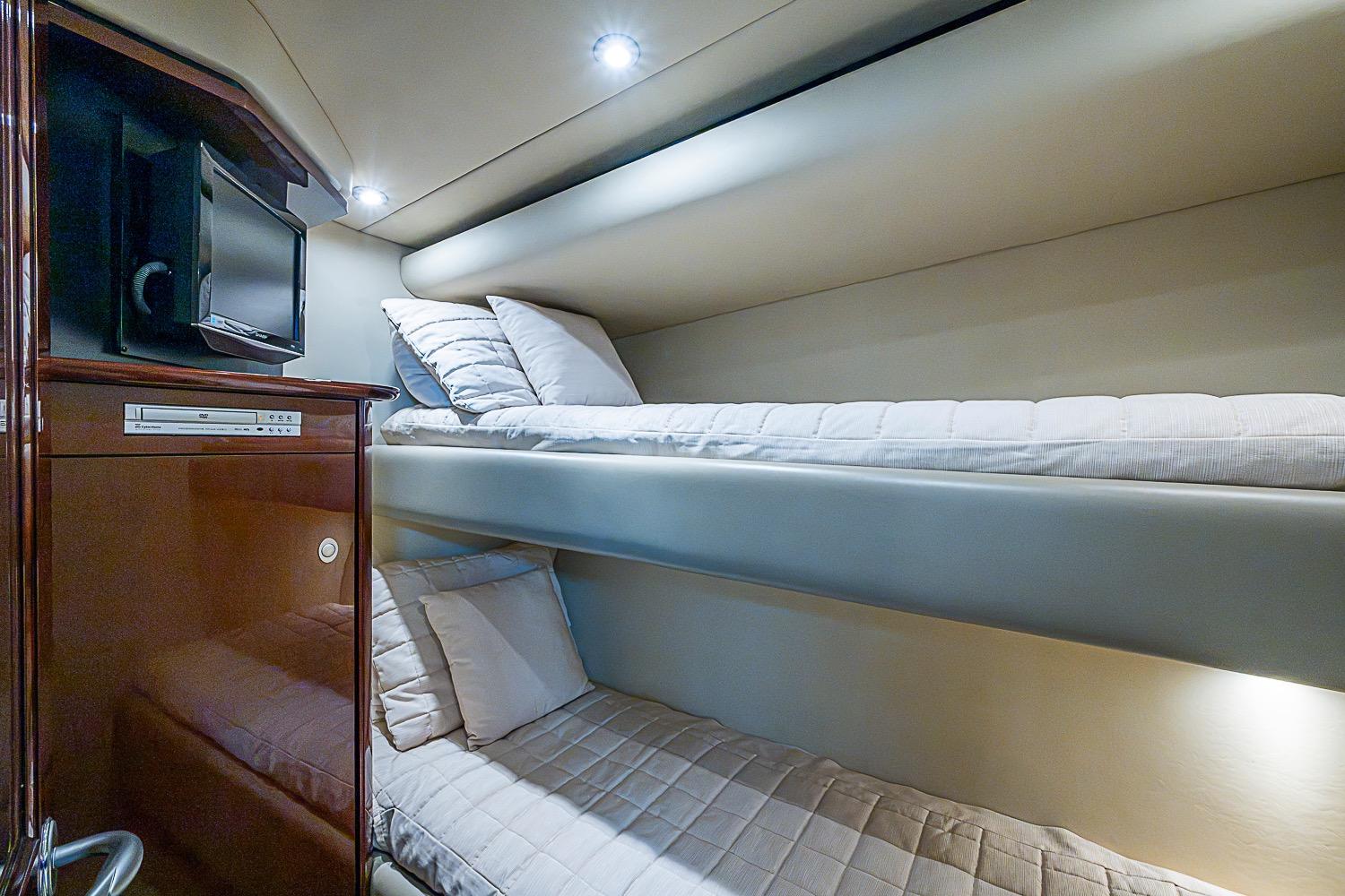 Luxurious 2008 Sea Ray 60 Sundancer yacht cabin with cozy bunk beds and modern amenities.