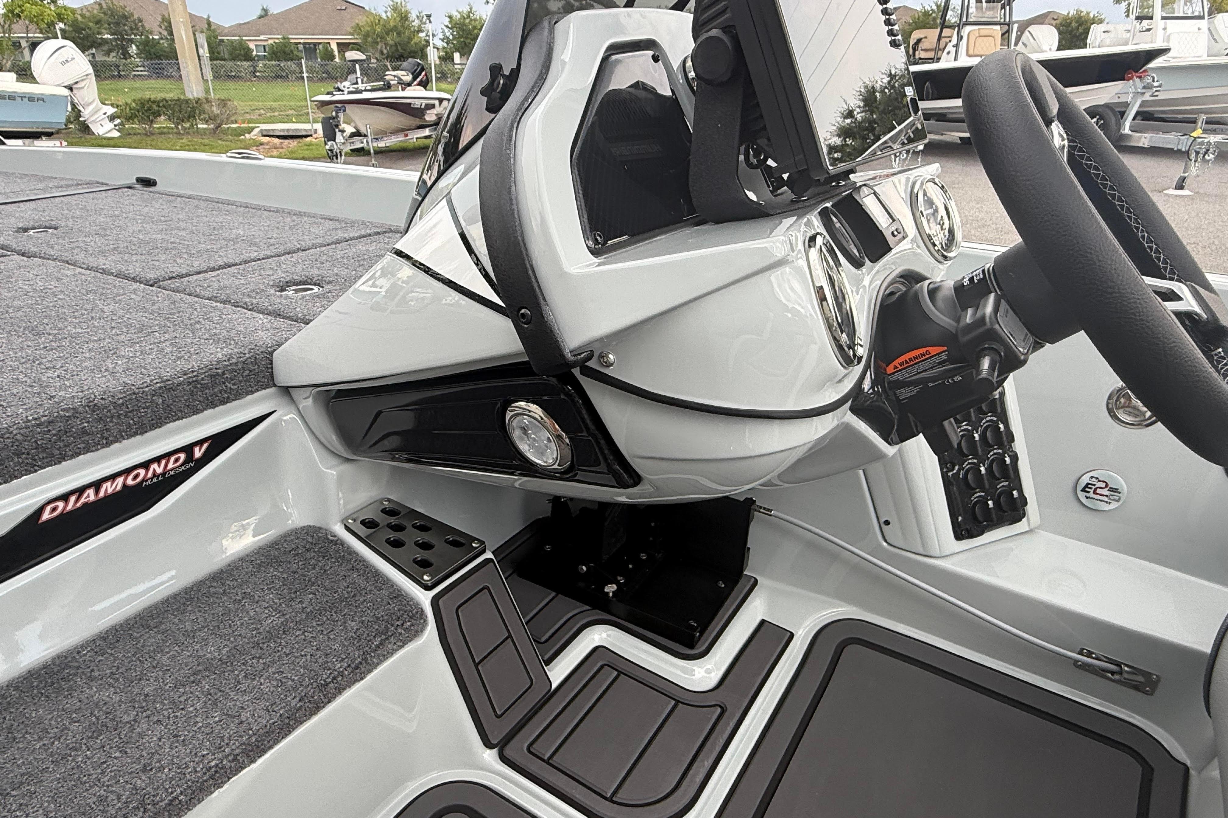 Interior of 2027 Phoenix 921 Elite X II boat, featuring steering wheel and dashboard controls.