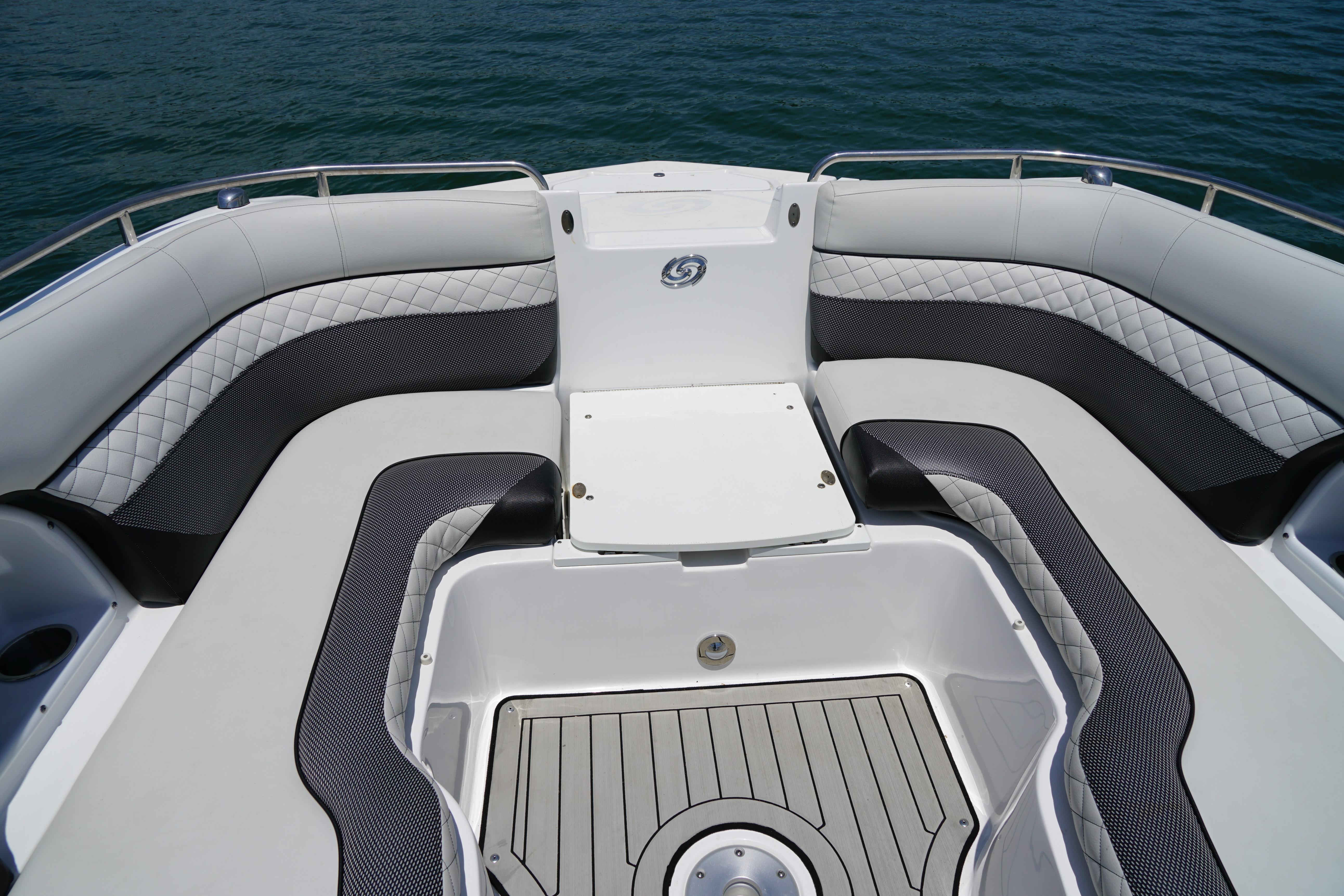 2020 Hurricane SunDeck 2486 OB boat interior with cushioned seating and sleek design.