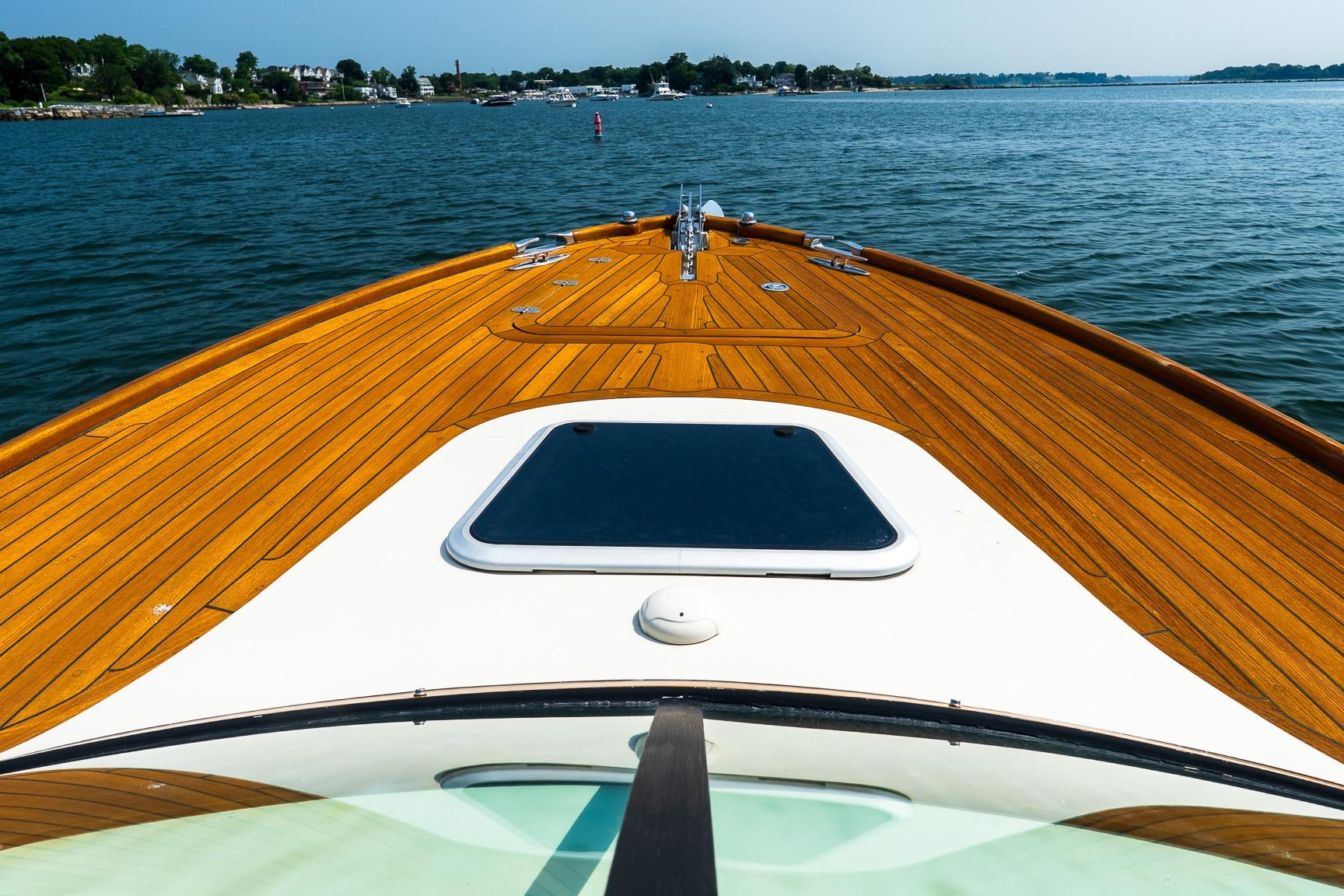 Hinckley Talaria 29R 2005 boat with teak deck cruising on calm waters.