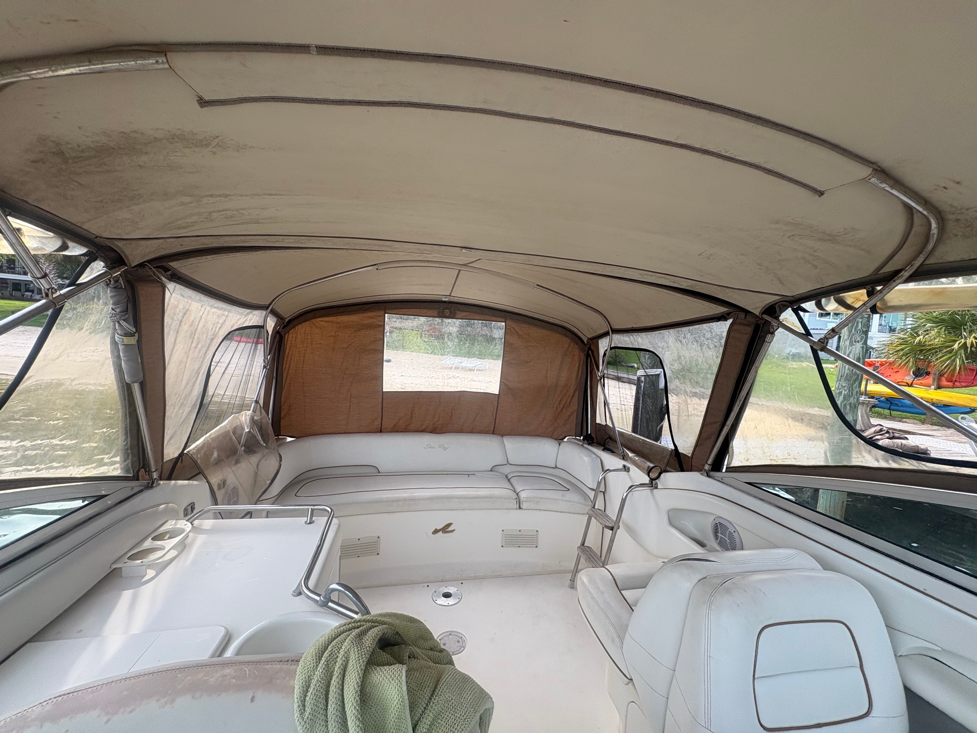 Interior of a 1996 Sea Ray 280 Cuddy Cabin with seating and canopy.