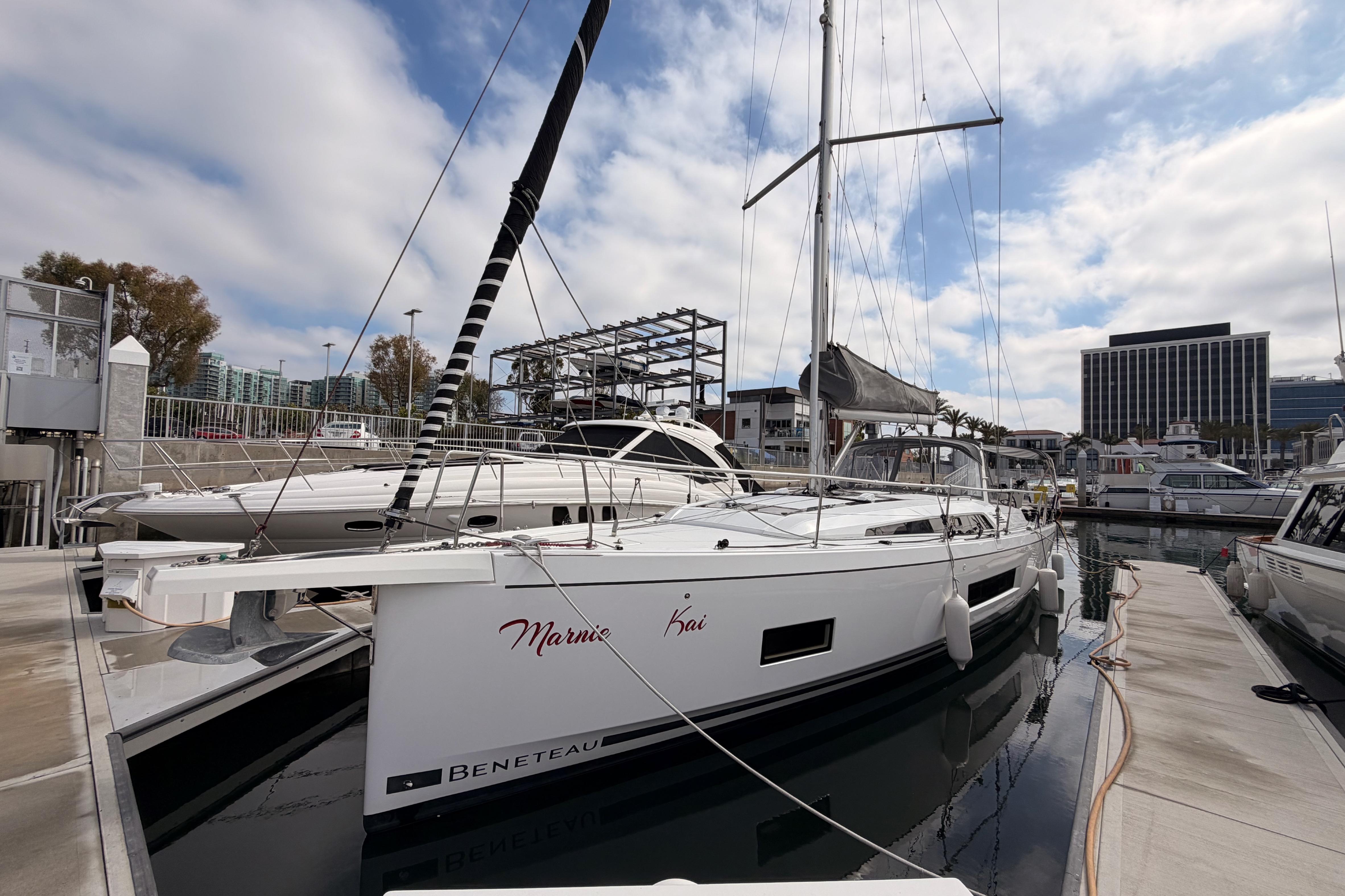2020 Beneteau Oceanis 46.1 yacht docked at marina under cloudy sky.